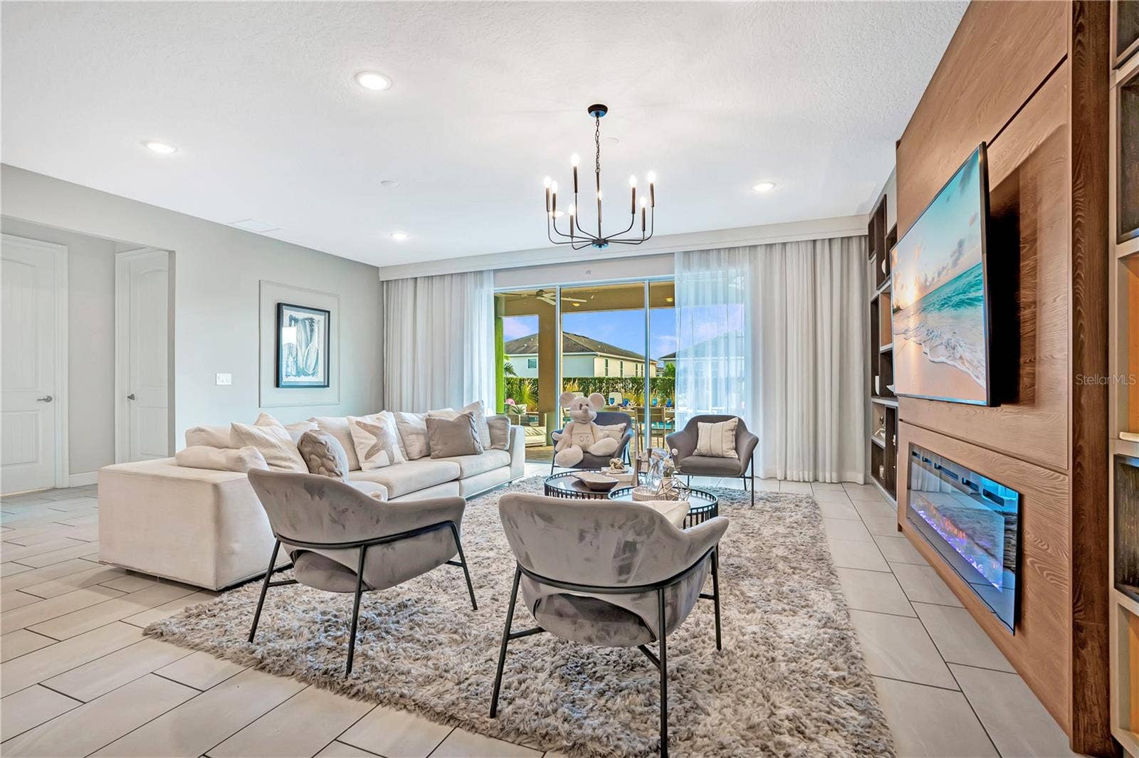 7704 WESTLAND DRIVE, Kissimmee, FL 34747 Custom entertainment wall with illuminated display shelving and a linear fireplace