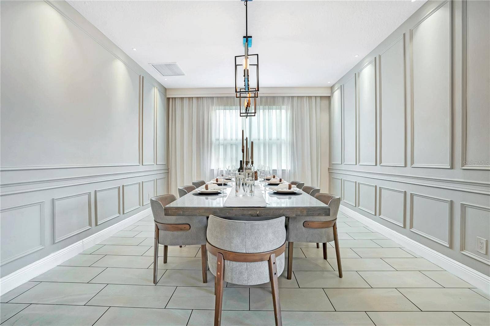 7704 WESTLAND DRIVE, Kissimmee, FL 34747 Refined formal dining with custom decorative millwork and seating for ten