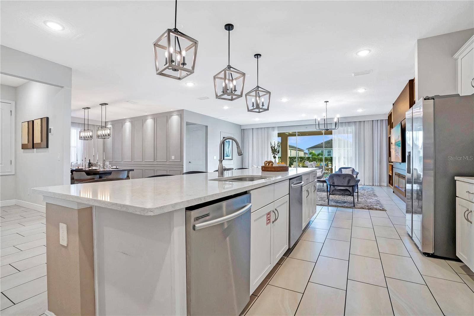 7704 WESTLAND DRIVE, Kissimmee, FL 34747 An expansive kitchen with oversized island opens directly to the main gathering spaces, creating a seamless environment for entertaining large groups