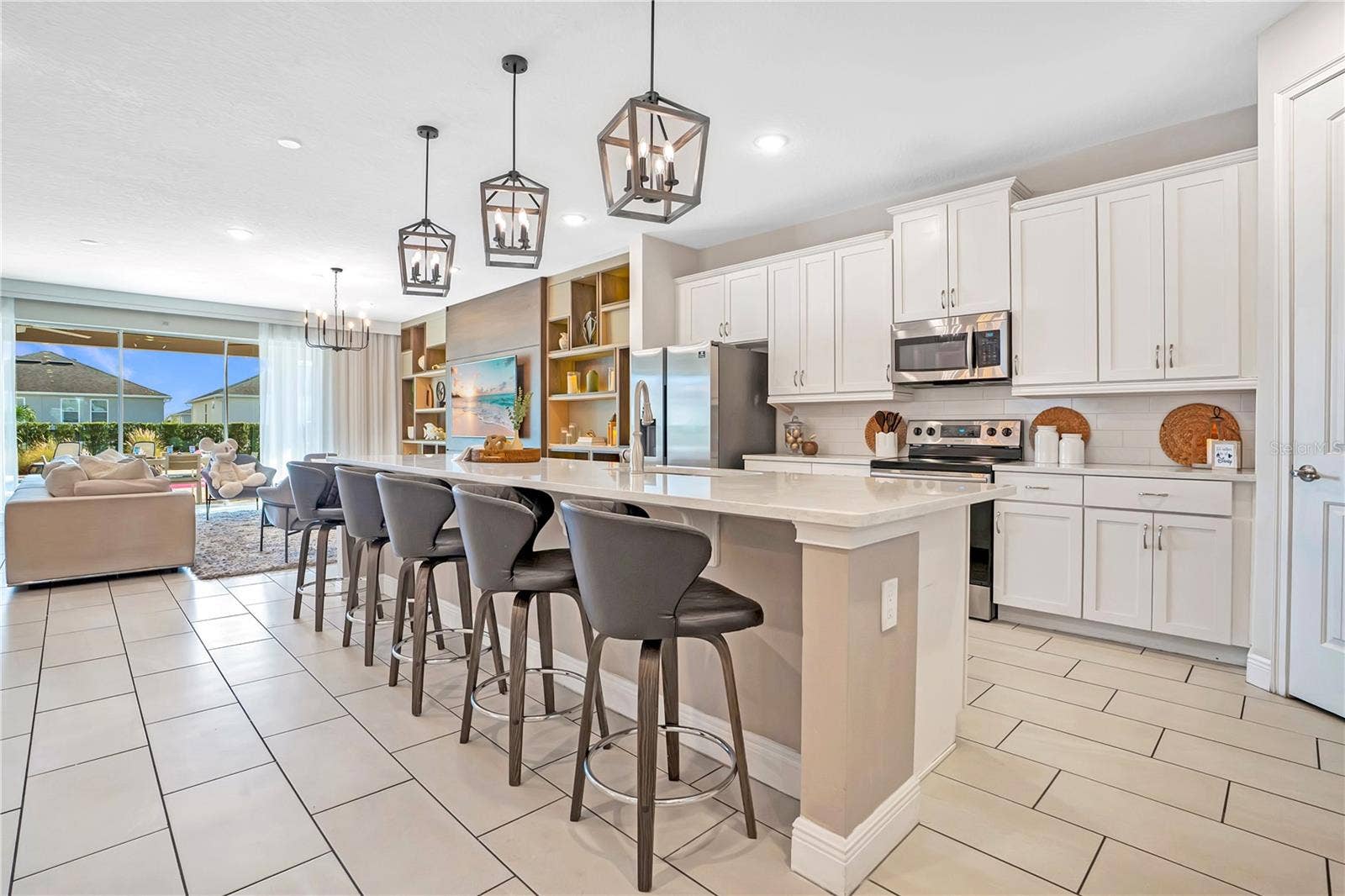 7704 WESTLAND DRIVE, Kissimmee, FL 34747 The expansive kitchen and adjoining living areas offer seamless flow, generous island seating, and an ideal layout for bringing everyone together