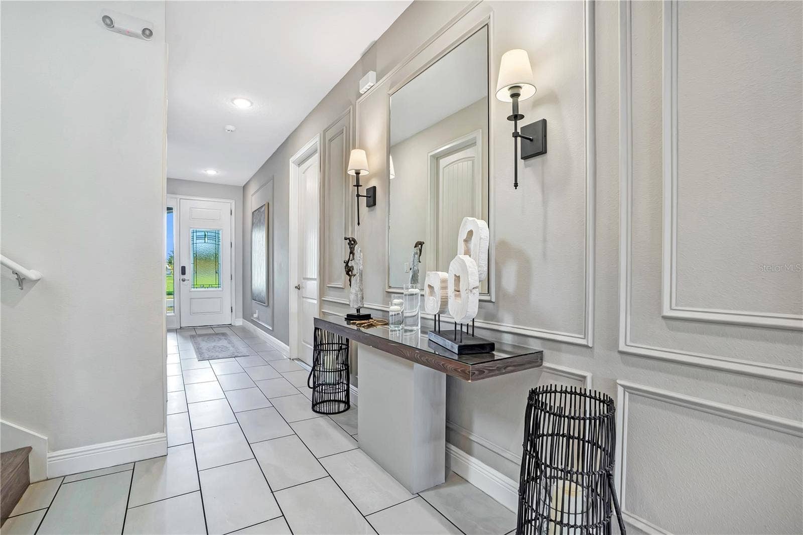 7704 WESTLAND DRIVE, Kissimmee, FL 34747 Beautiful architectural millwork, decorative wall detailing, and designer accents create a refined arrival experience