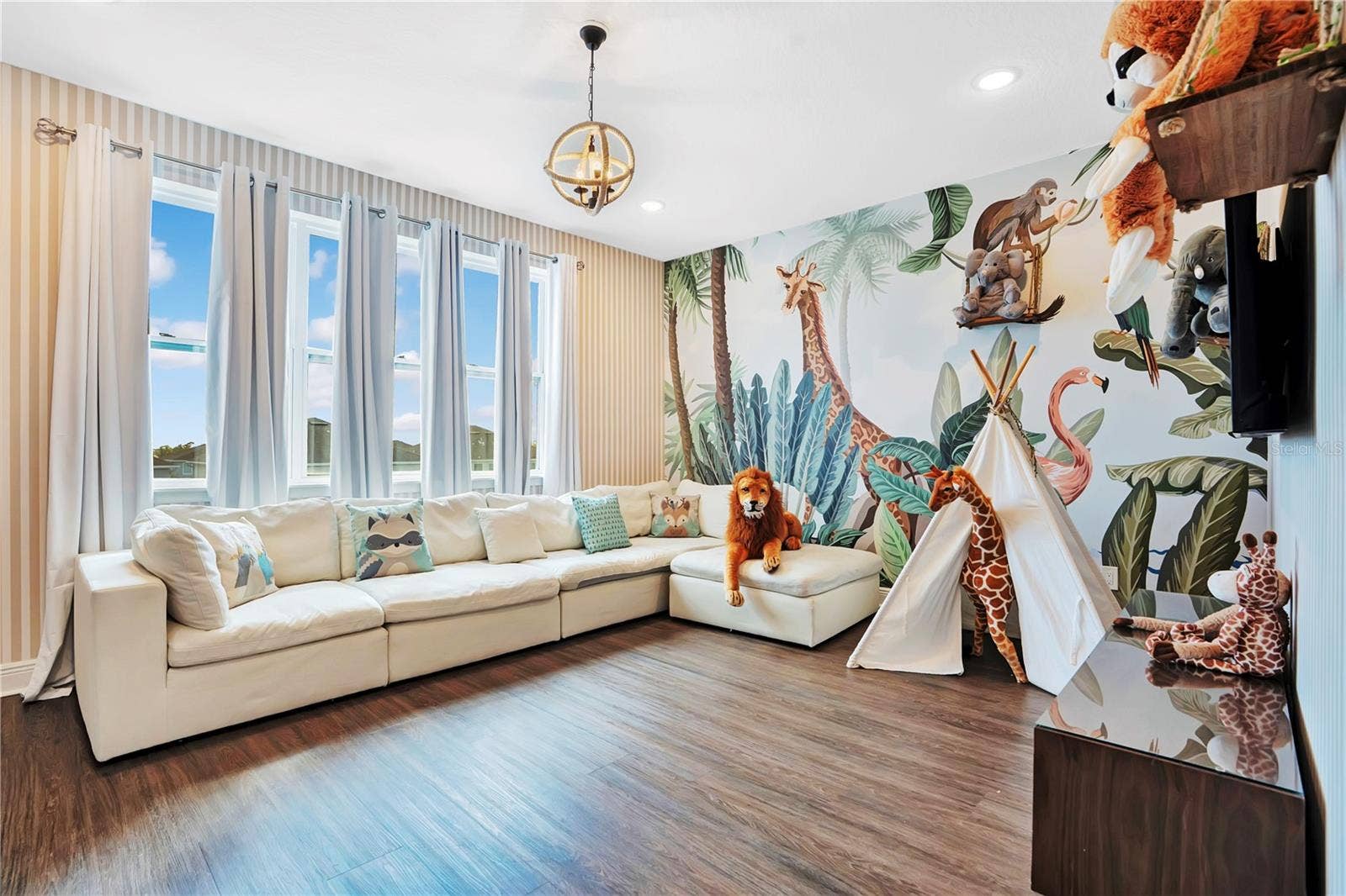 7704 WESTLAND DRIVE, Kissimmee, FL 34747 An enchanting Jungle Book-inspired loft brings the magic of the jungle to life with vibrant custom murals, whimsical details, and a welcoming space for guests of all ages to gather and unwind