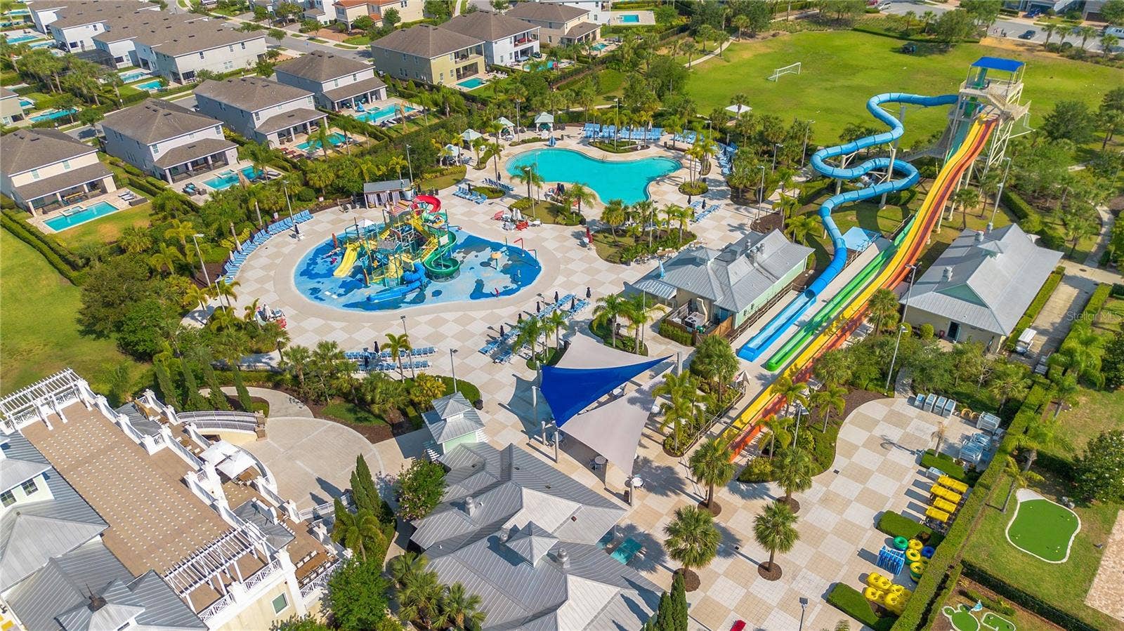 7704 WESTLAND DRIVE, Kissimmee, FL 34747 A tropical resort experience with sparkling pools, waterslides, and inviting gathering spaces