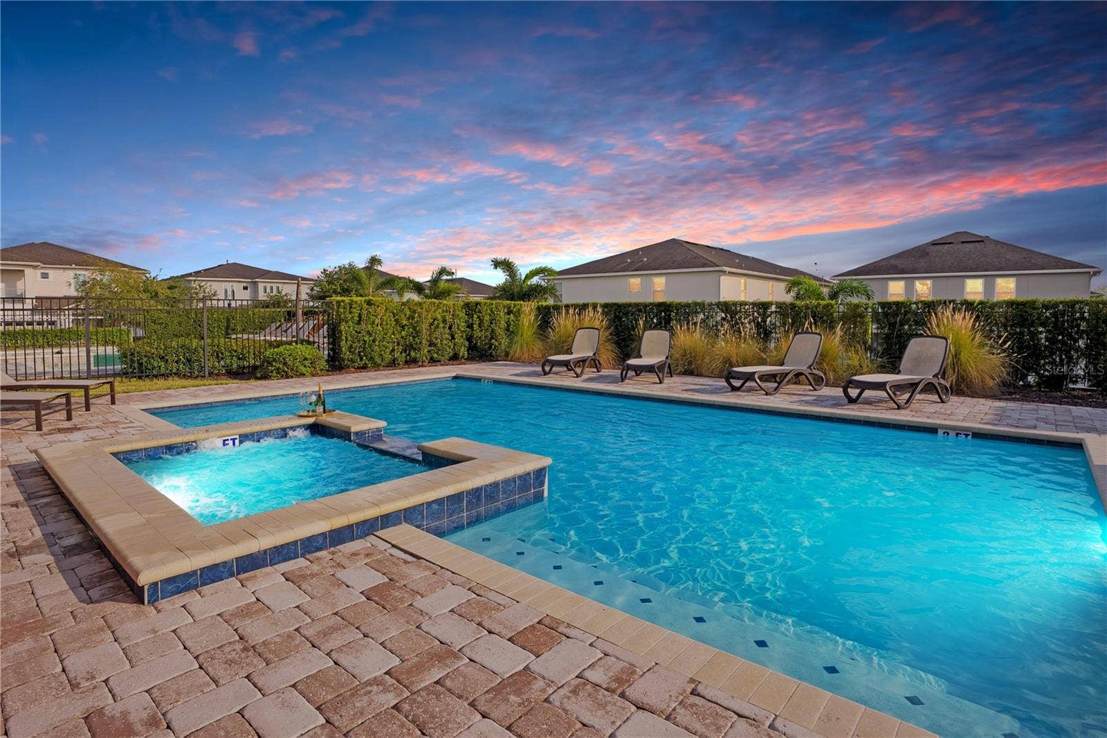 7704 WESTLAND DRIVE, Kissimmee, FL 34747 Evenings by the pool, the perfect ending to a day of Florida adventures