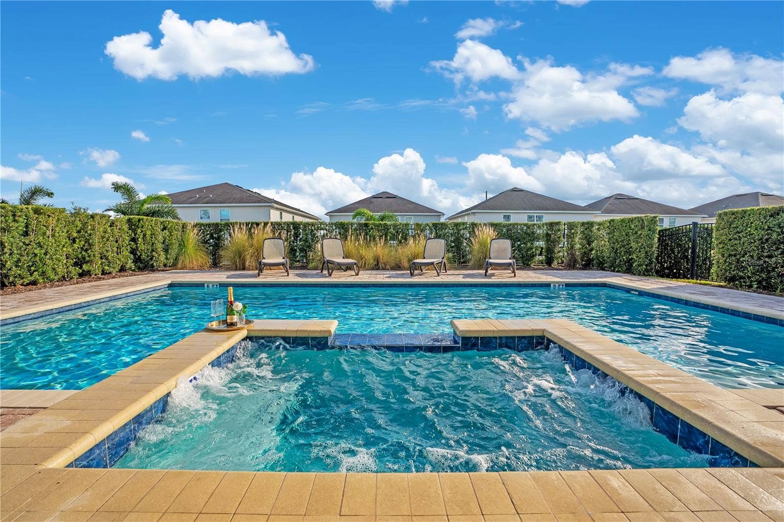 7704 WESTLAND DRIVE, Kissimmee, FL 34747 An oversized private pool with heated spillover spa and a beautifully paved deck