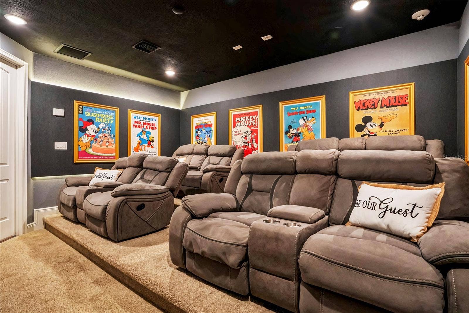 7704 WESTLAND DRIVE, Kissimmee, FL 34747 The Wonderful World of Disney Theater delivers a cinematic experience with plush reclining seating, dramatic lighting, and vibrant Disney-inspired artwork