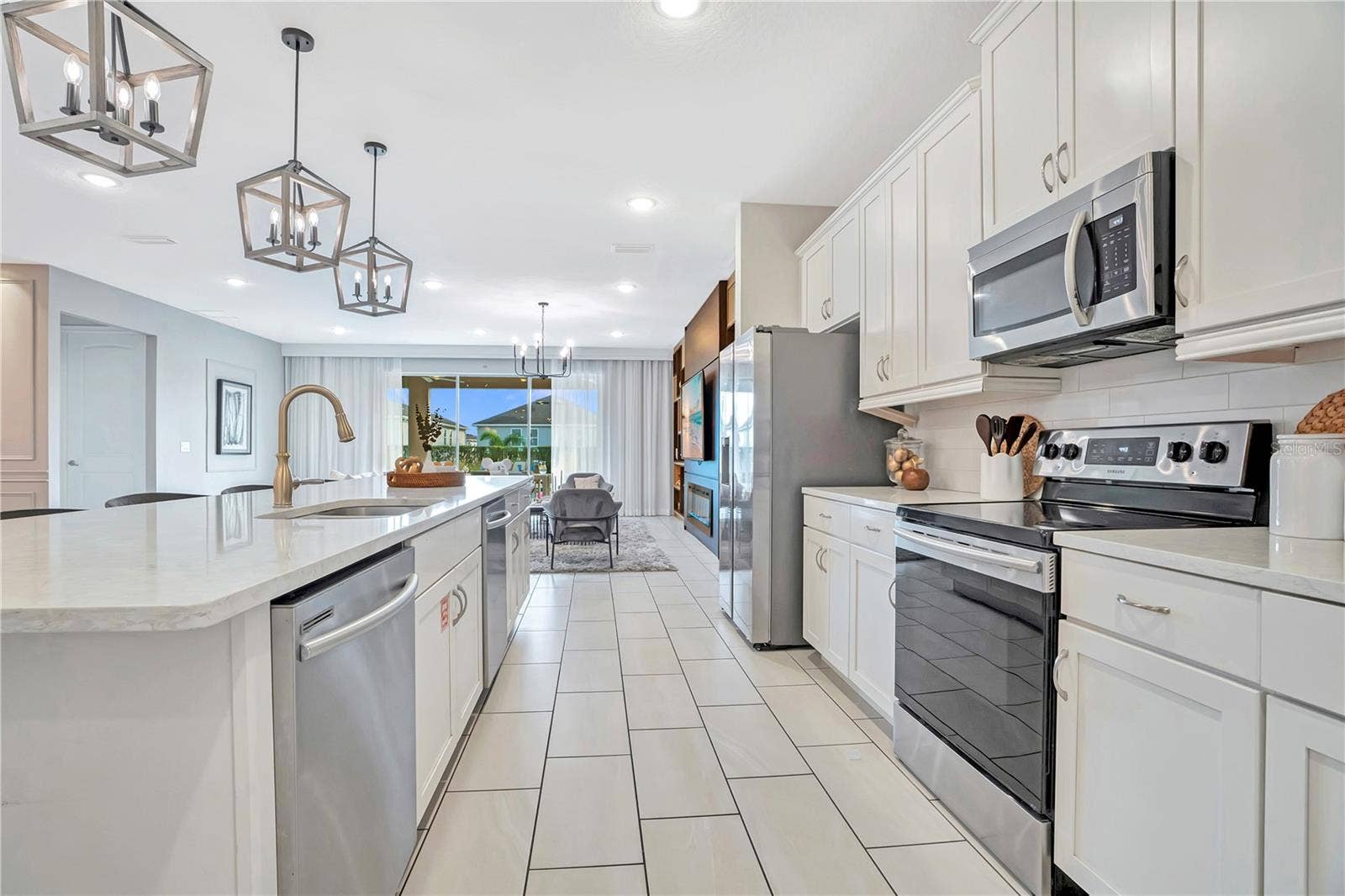7704 WESTLAND DRIVE, Kissimmee, FL 34747 A beautifully equipped kitchen combines abundant cabinetry, stainless steel appliances, generous preparation space, and an inviting open layout