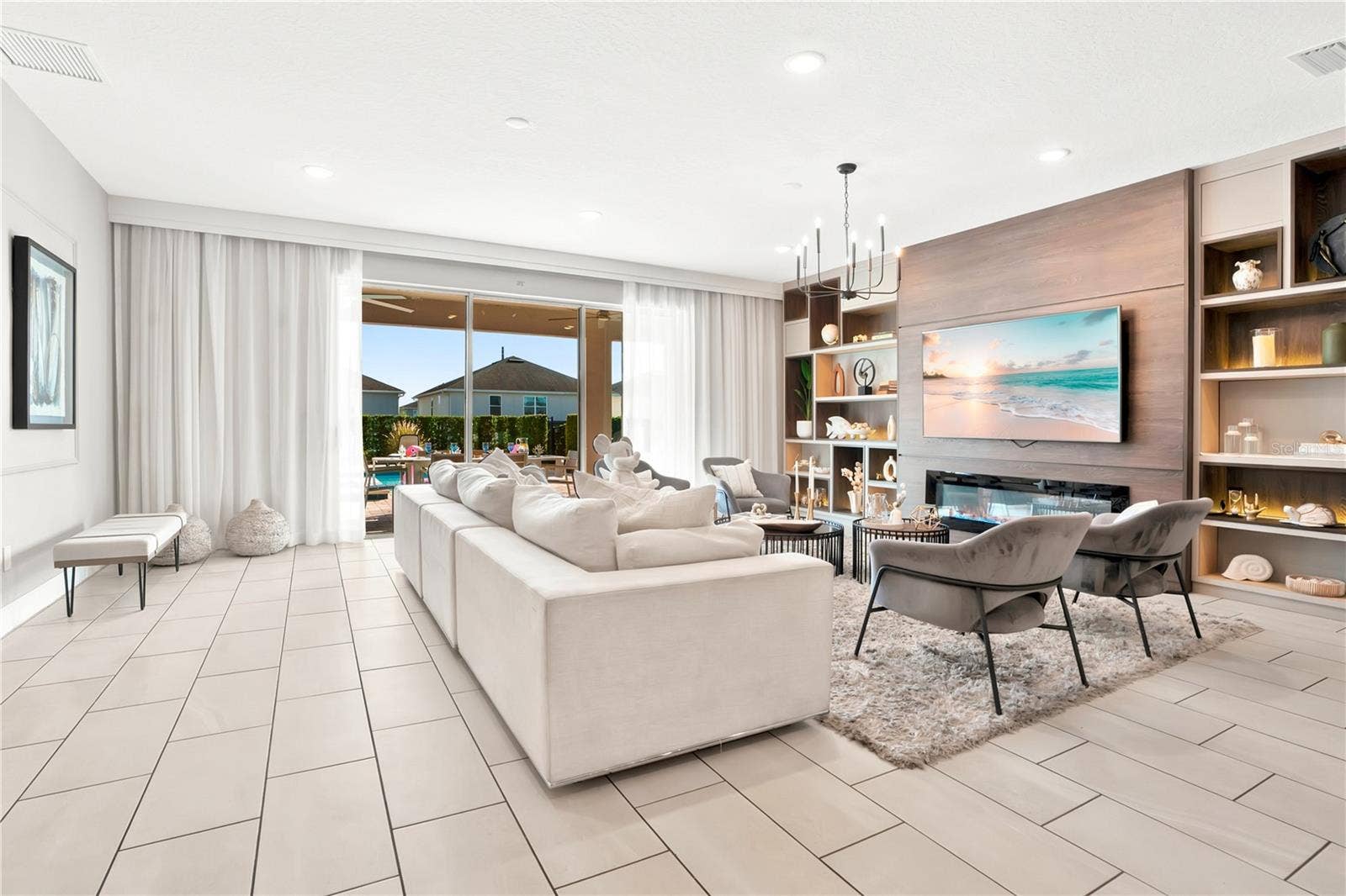7704 WESTLAND DRIVE, Kissimmee, FL 34747 Sophisticated comfort, custom draperies, and seamless indoor-outdoor views