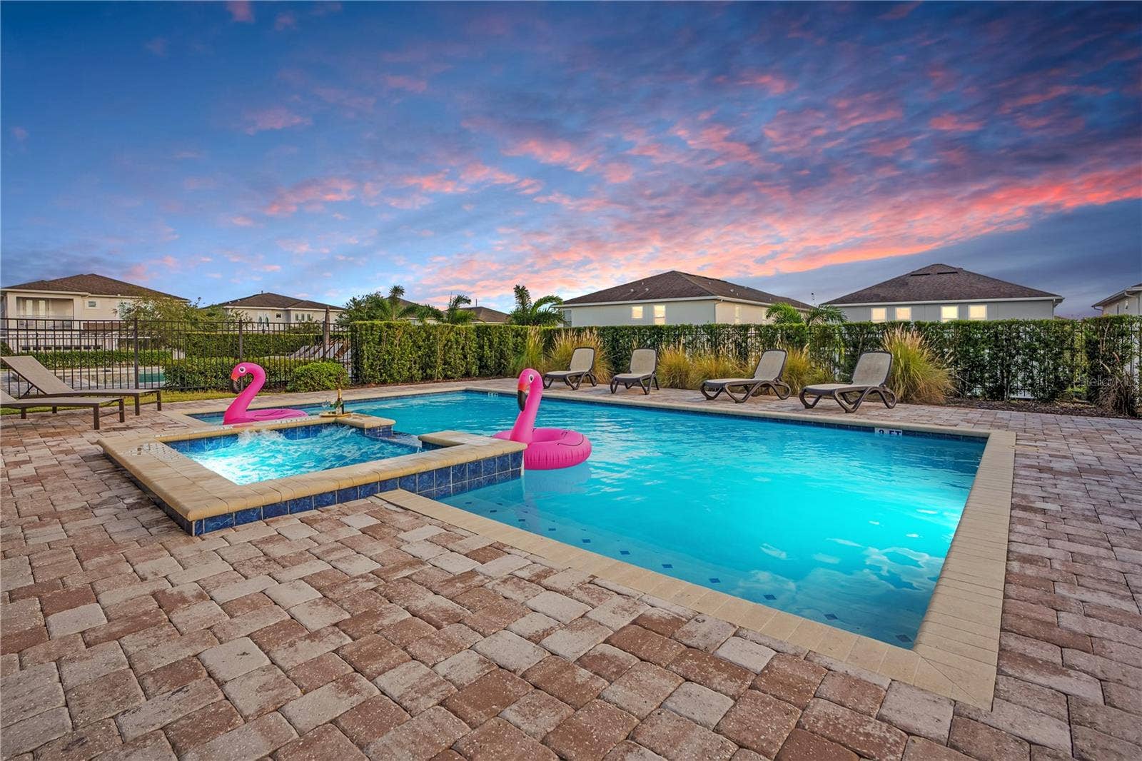 7704 WESTLAND DRIVE, Kissimmee, FL 34747 Your private resort experience awaits, featuring a spectacular pool, expansive paver deck, and inviting outdoor spaces for relaxation and entertainment