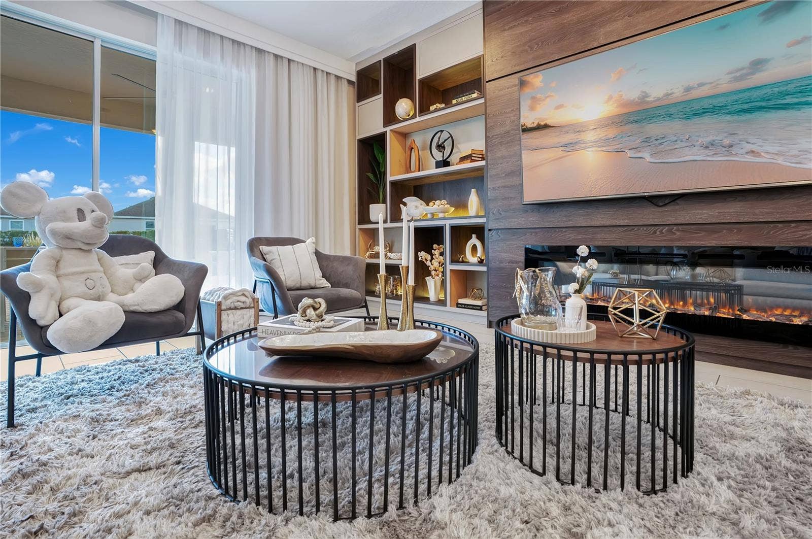 7704 WESTLAND DRIVE, Kissimmee, FL 34747 Custom built-ins, integrated lighting, and a striking fireplace feature