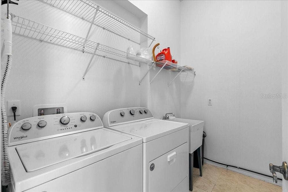 laundry room with washer, dryer and separate sink