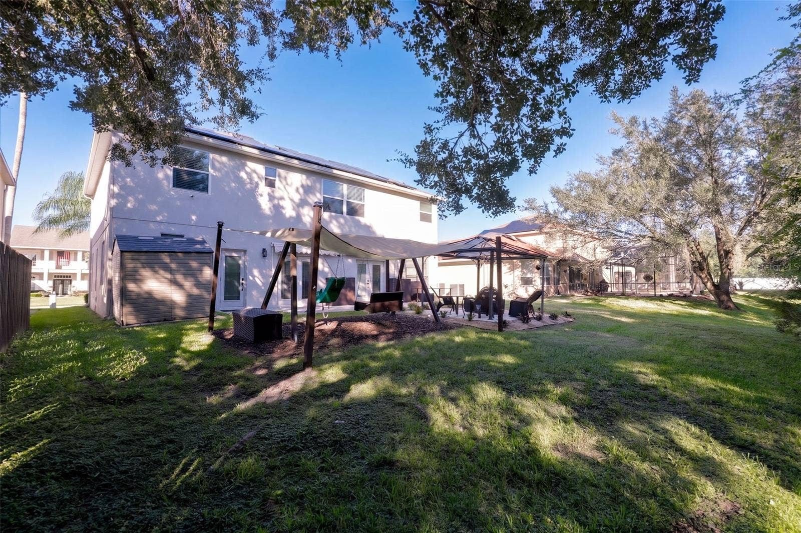 10603 SUNRISE TERRACE DRIVE, Orlando, FL 32825 Back yard with swing set
