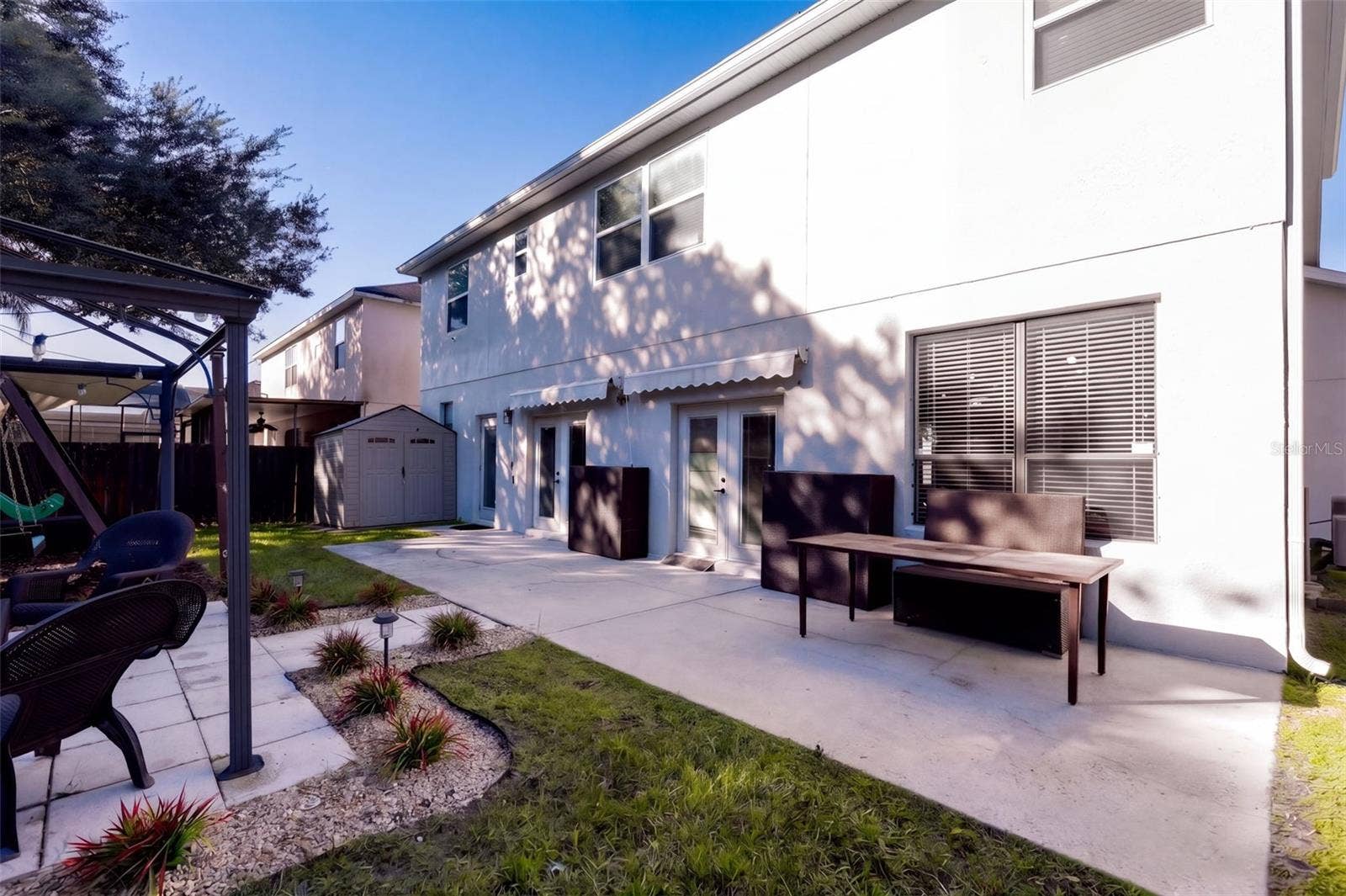 10603 SUNRISE TERRACE DRIVE, Orlando, FL 32825 Back yard patio with double awning
