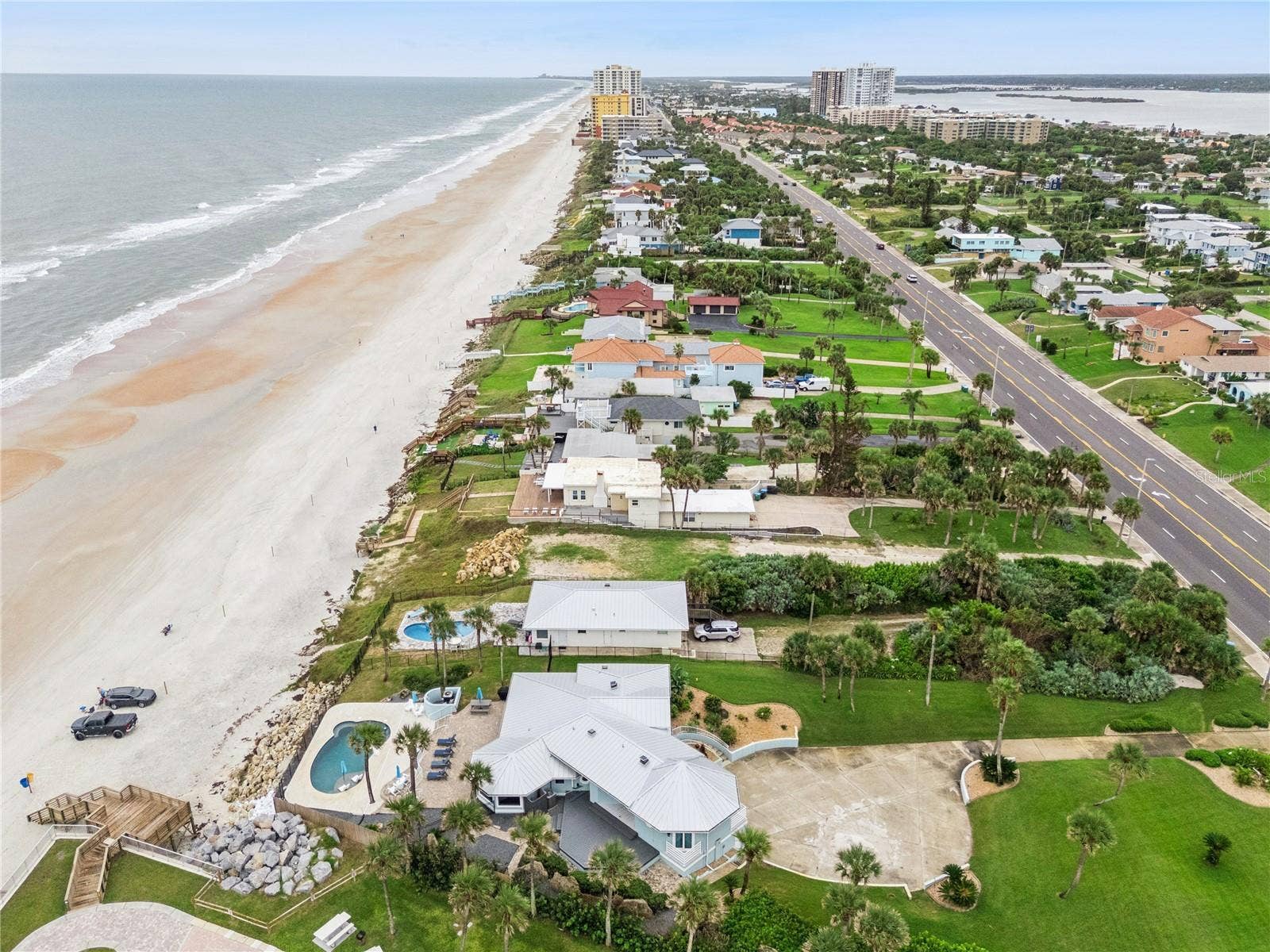 Set on over three-quarters of an acre with approximately 85 feet of ocean frontage, this property offers a generous setback from the road, ample driveway parking, and an attached garage. Neighboring Frank Rendon Park features a playground, covered picnic areas, restrooms, public beach access, and parking.