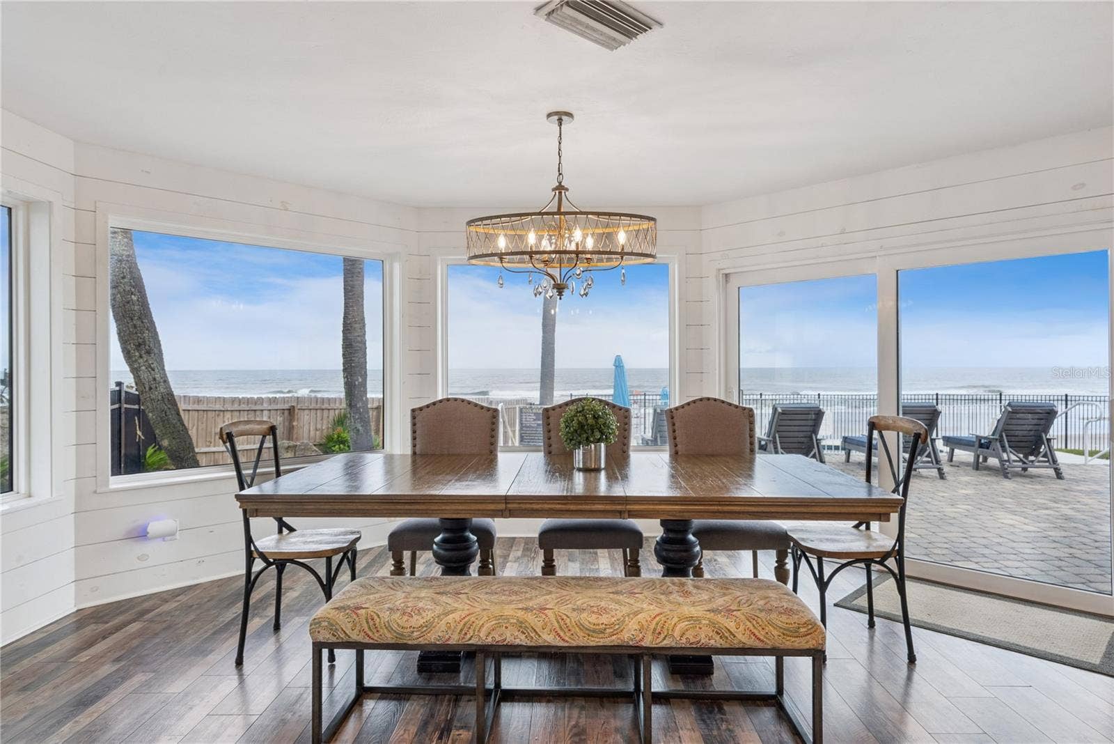 Spacious eat-in kitchen with stainless steel appliances, quartz countertops, breakfast bar seating, and beautiful ocean viewsan inviting setting for casual meals and gathering.