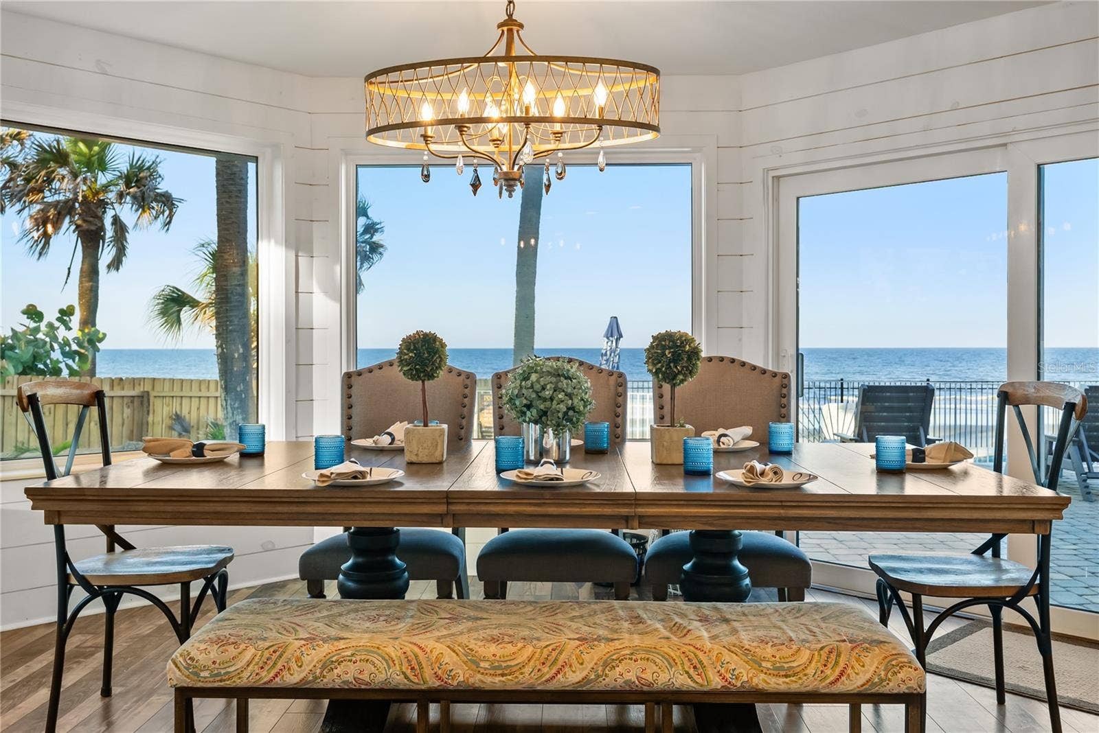 Spacious eat-in kitchen with stainless steel appliances, quartz countertops, breakfast bar seating, and beautiful ocean viewsan inviting setting for casual meals and gathering.