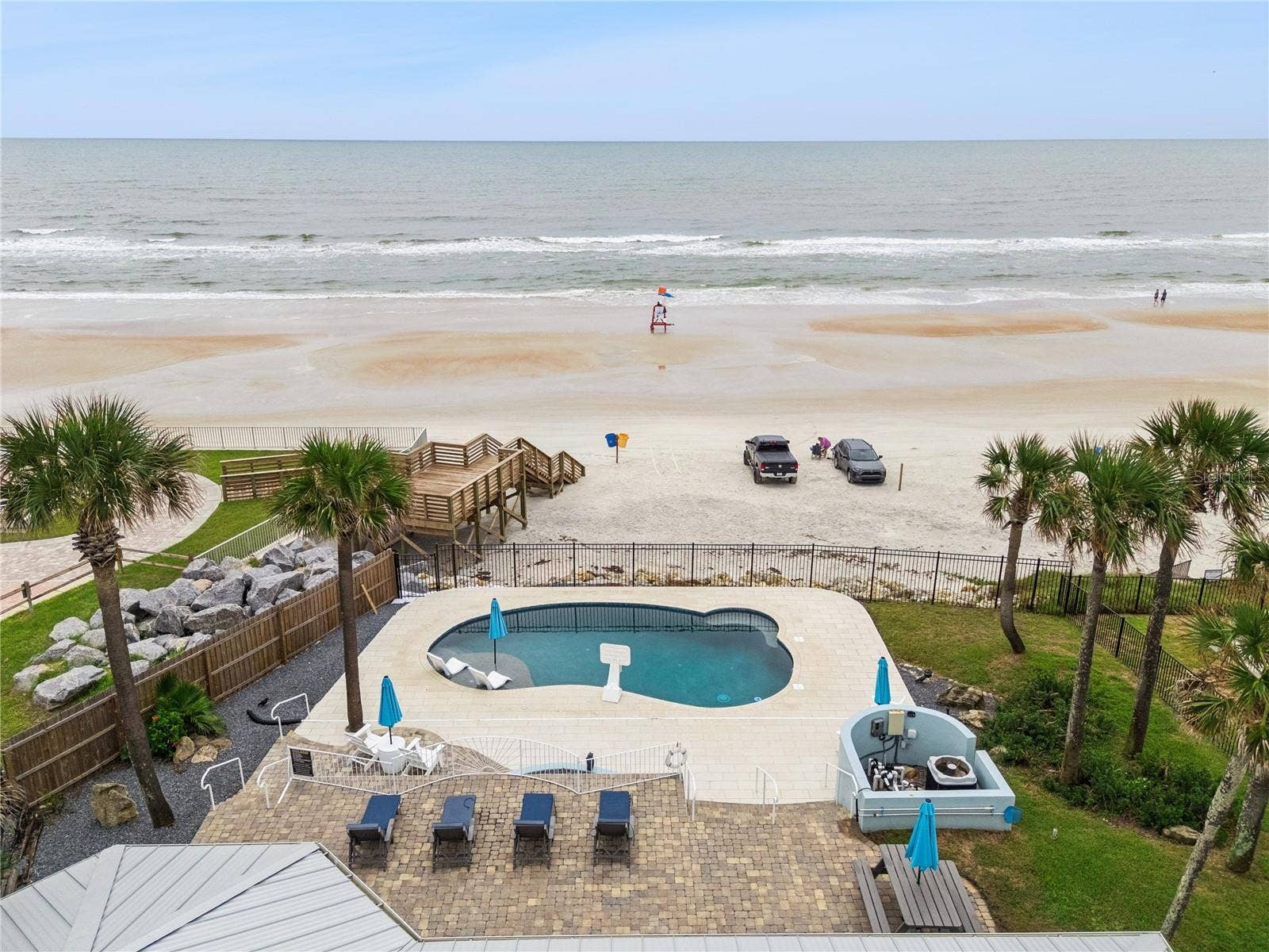 new poolNew oceanfront pool installed in 2024, featuring heating, a sun shelf, bubblers, and a 7-foot-deep end, with expansive patio space and panoramic Atlantic views.