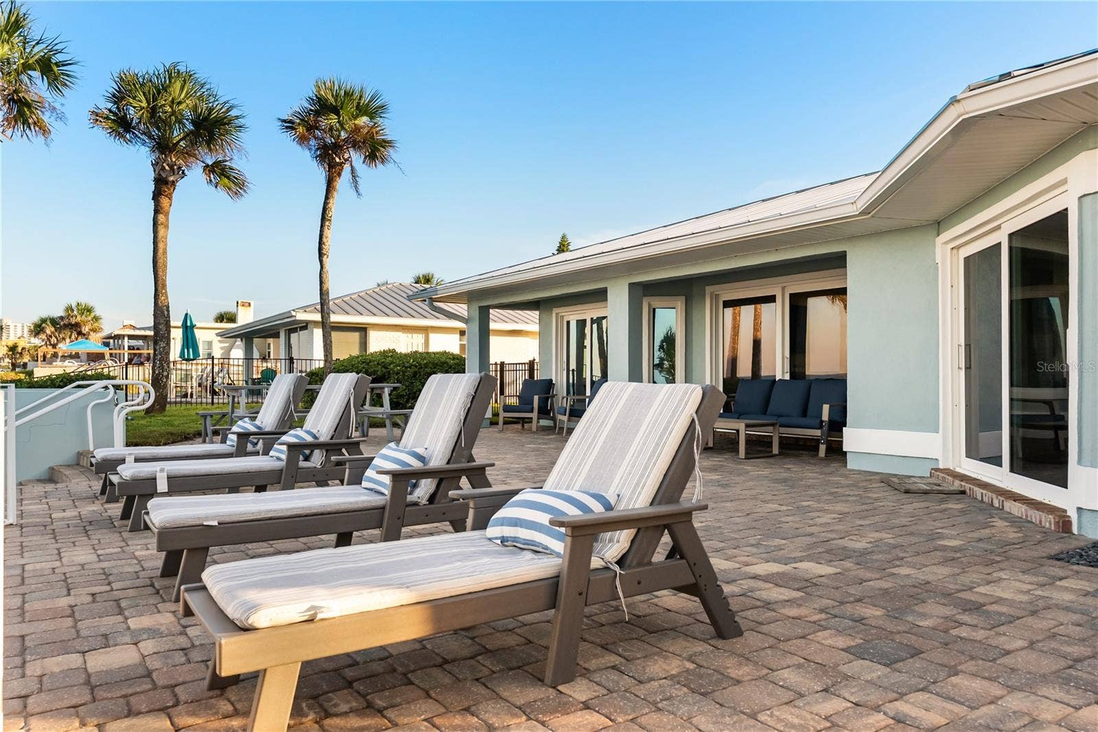 new poolNew oceanfront pool installed in 2024, featuring heating, a sun shelf, bubblers, and a 7-foot-deep end, with expansive patio space and panoramic Atlantic views