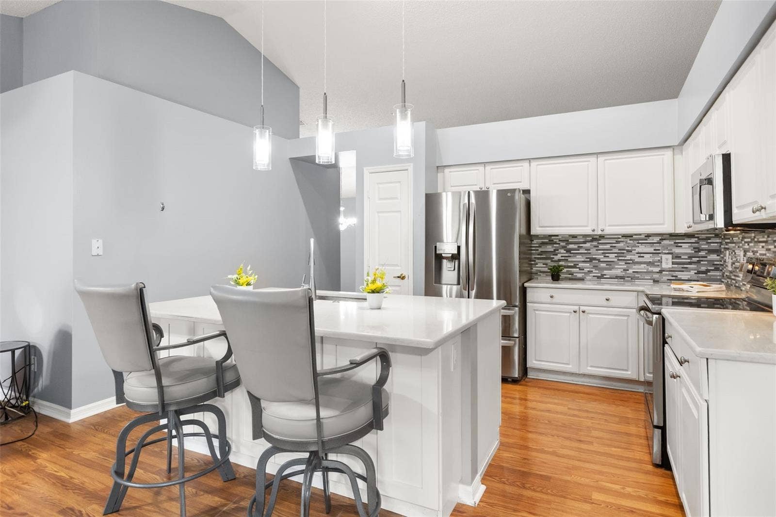 Large island for extra seating and there's cabinets for extra storage