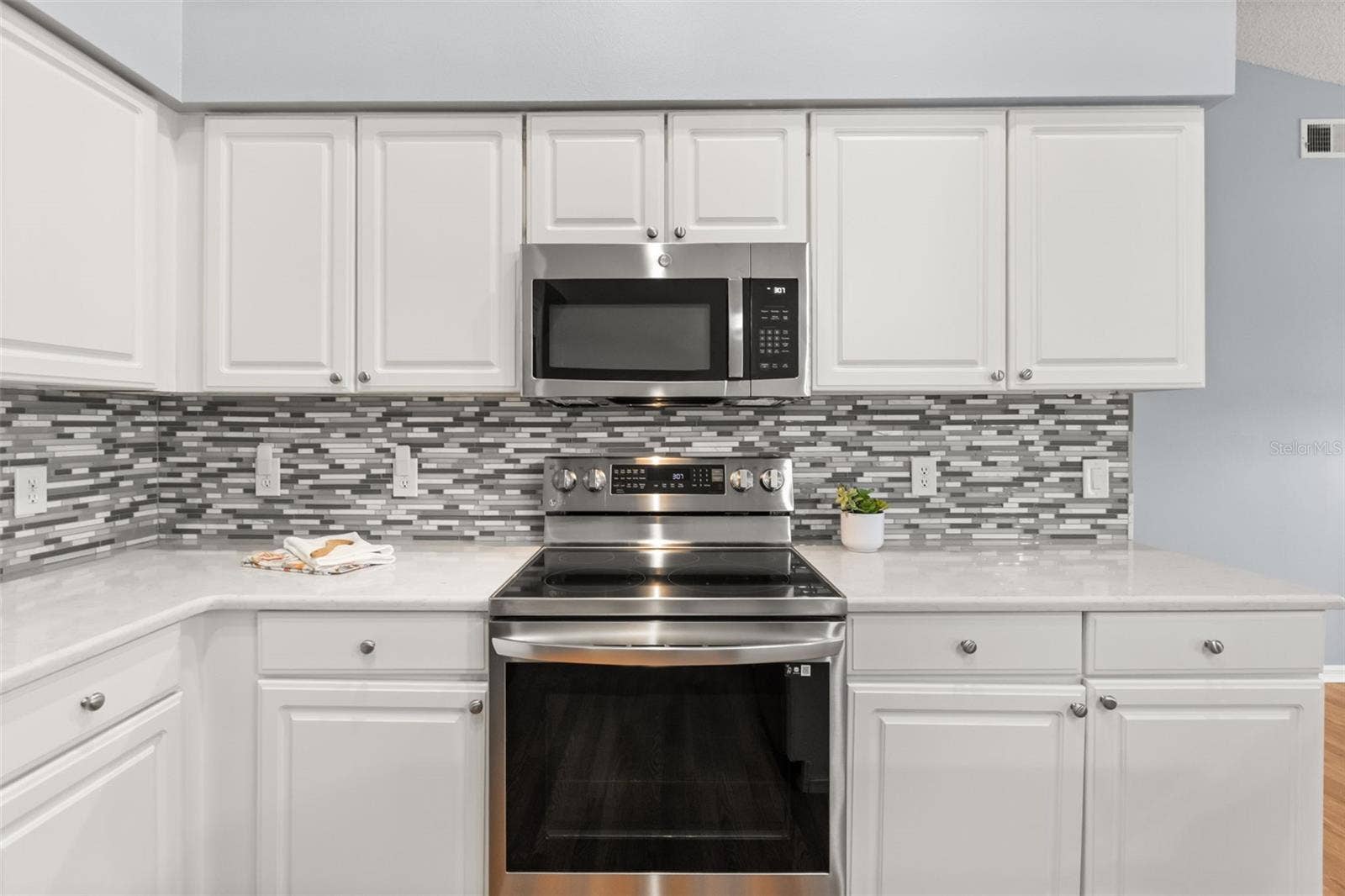 Quartz counters and tiled backsplash