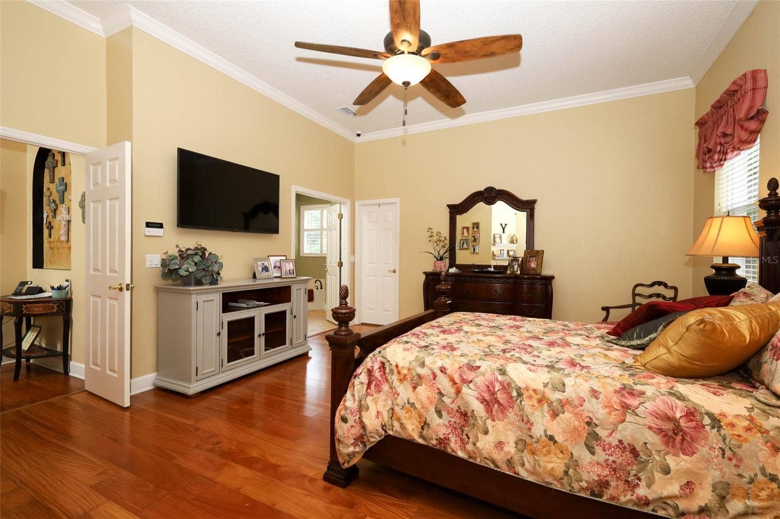 Owners suite with large walk-in closet that has custom built-ins