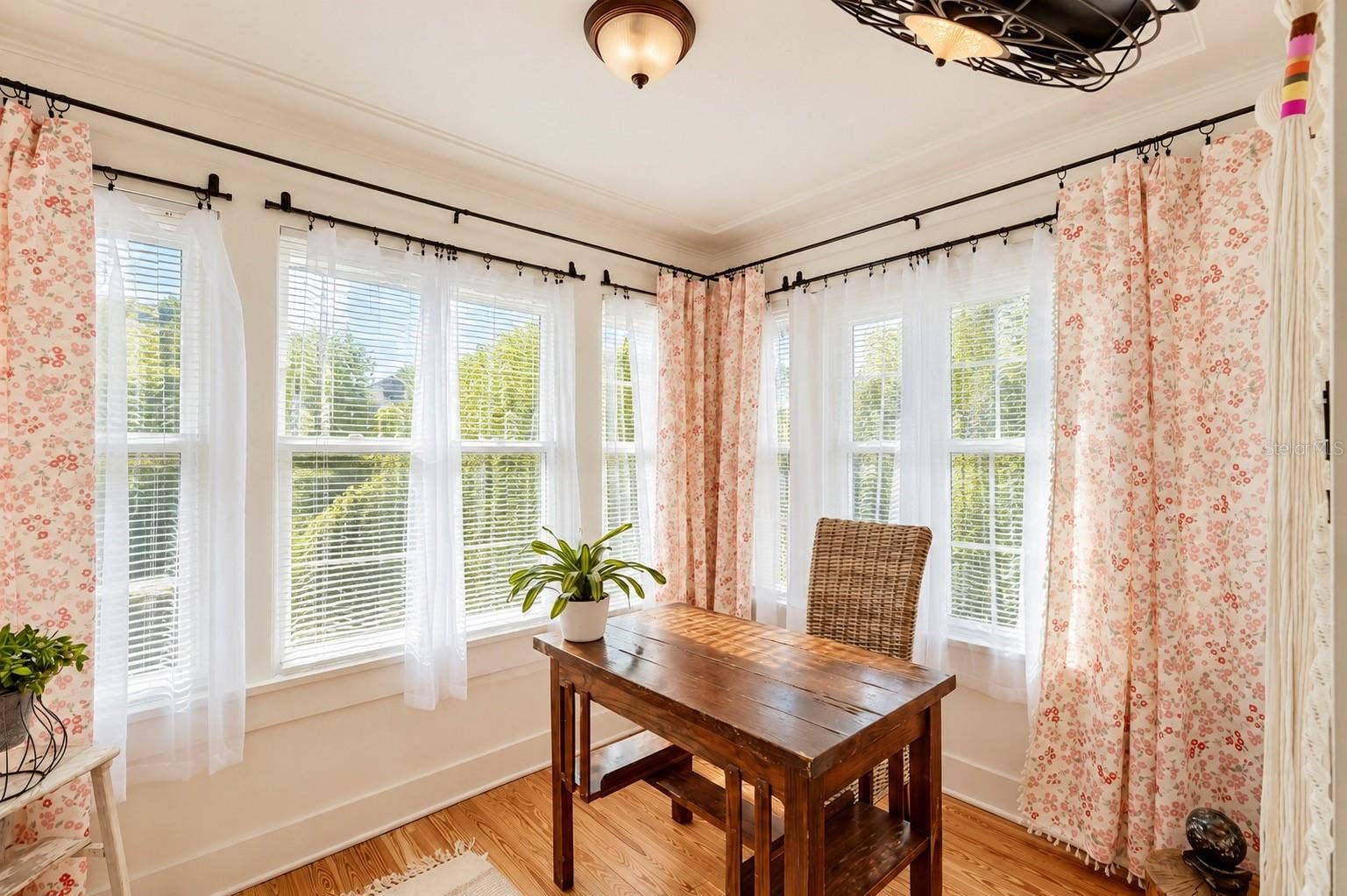 1901 10TH STREET, St Cloud, FL 34769 Bright and inviting SUNROOM featuring an abundance of natural light, beautiful hardwood floors, and DOUBLE FRENCH DOORS. Currently used as a home office, this versatile space offers endless possibilities as a guest room, reading retreat, or cozy sitting area!