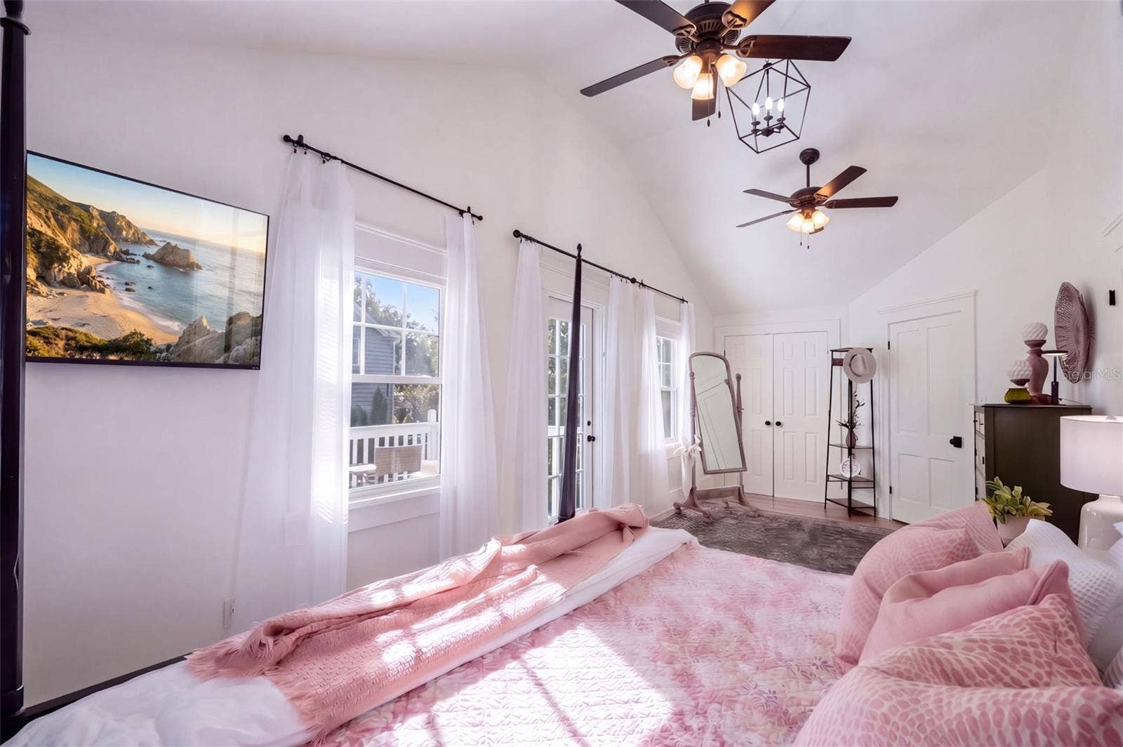 1901 10TH STREET, St Cloud, FL 34769 Beautiful UPSTAIRS PRIMARY BEDROOM featuring soaring vaulted ceilings, abundant natural light, and TWO CLOSETS, including a spacious WALK-IN CLOSET and a BUILT-IN CLOSET for additional storage. Charming FRENCH DOORS open to a cozy PRIVATE BALCONY, creating the perfect retreat to enjoy your morning coffee or unwind at the end of the day!