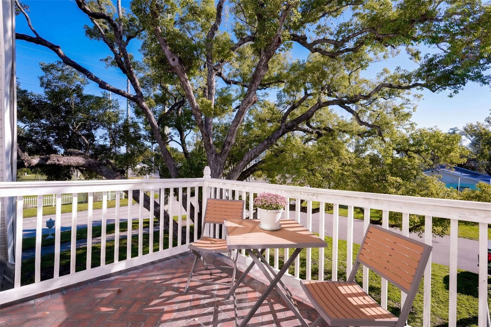 1901 10TH STREET, St Cloud, FL 34769 Step outside the UPSTAIRS PRIMARY BEDROOM onto your own charming PRIVATE BALCONY, the perfect retreat for enjoying morning coffee or relaxing with an evening beverage while taking in the beautiful views of mature oak trees and the peaceful surroundings!
