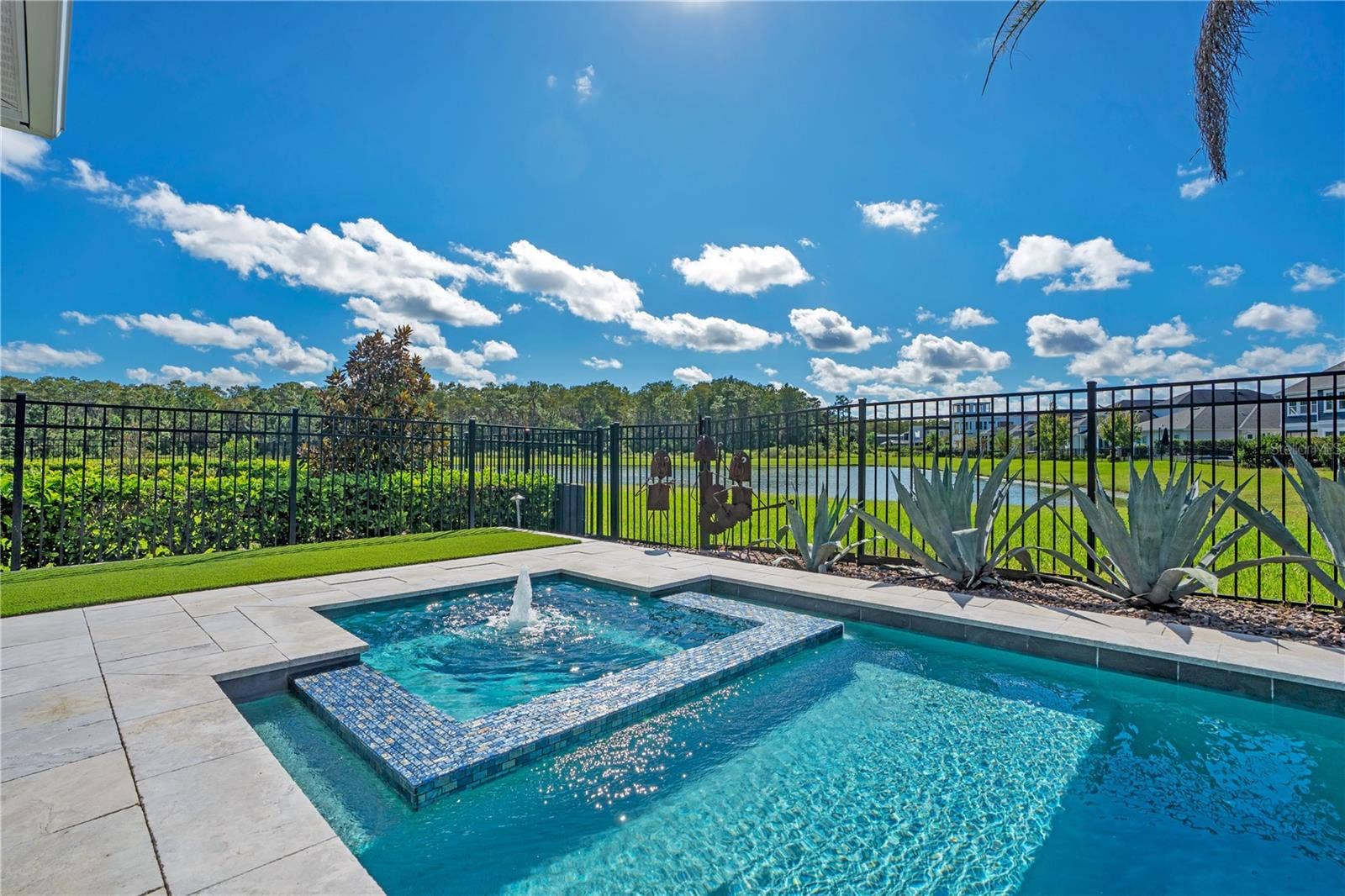 8336 CANETTI STREET, Orlando, FL 32827 Heated salt water pool and spa with open sky and a peaceful water and conservation view.