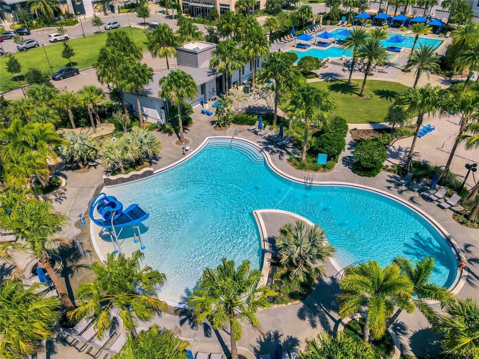 8336 CANETTI STREET, Orlando, FL 32827 Community resort style pool with lush landscaping and lounge areas.