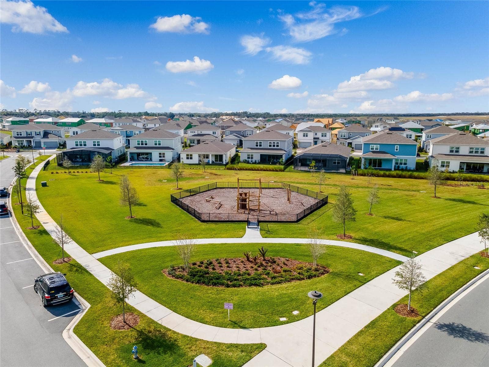 8336 CANETTI STREET, Orlando, FL 32827 Landscaped neighborhood park with winding walking paths in Laureate Park.
