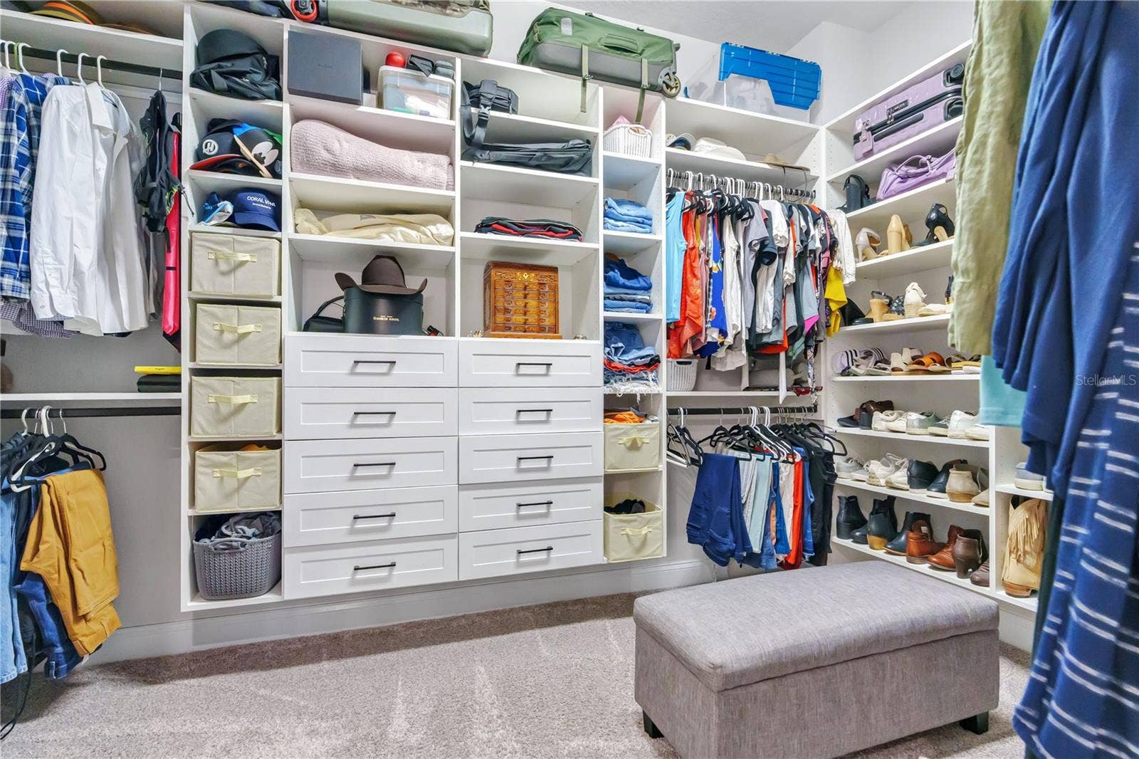 8336 CANETTI STREET, Orlando, FL 32827 Oversized primary walk in closet with custom built ins, shelving, and drawers for organized storage.