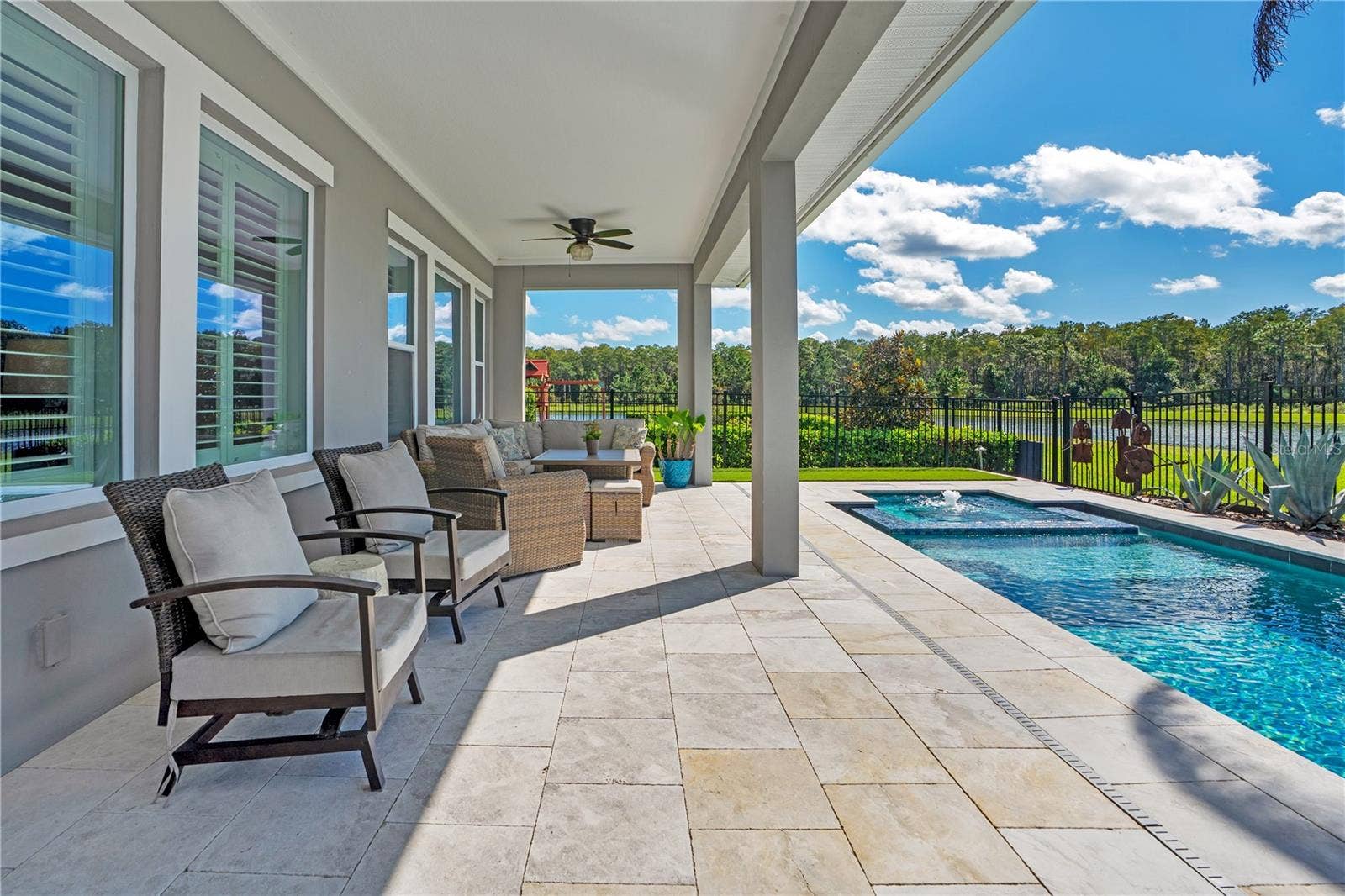8336 CANETTI STREET, Orlando, FL 32827 Extended covered lanai overlooking the pool and water and conservation view. Pre wired for surround sound.
