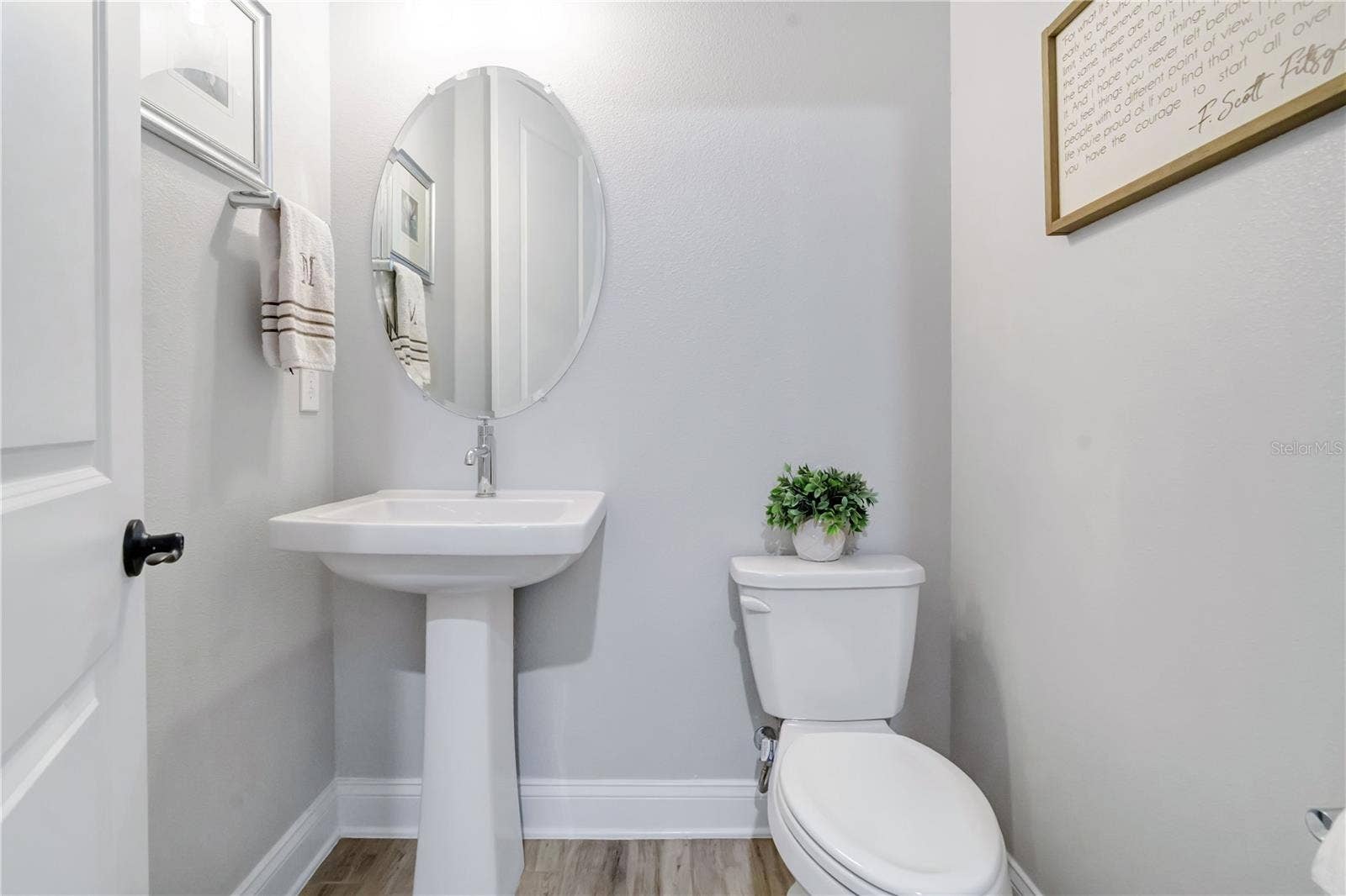 8336 CANETTI STREET, Orlando, FL 32827 Convenient half bath with pedestal sink and modern finishes.