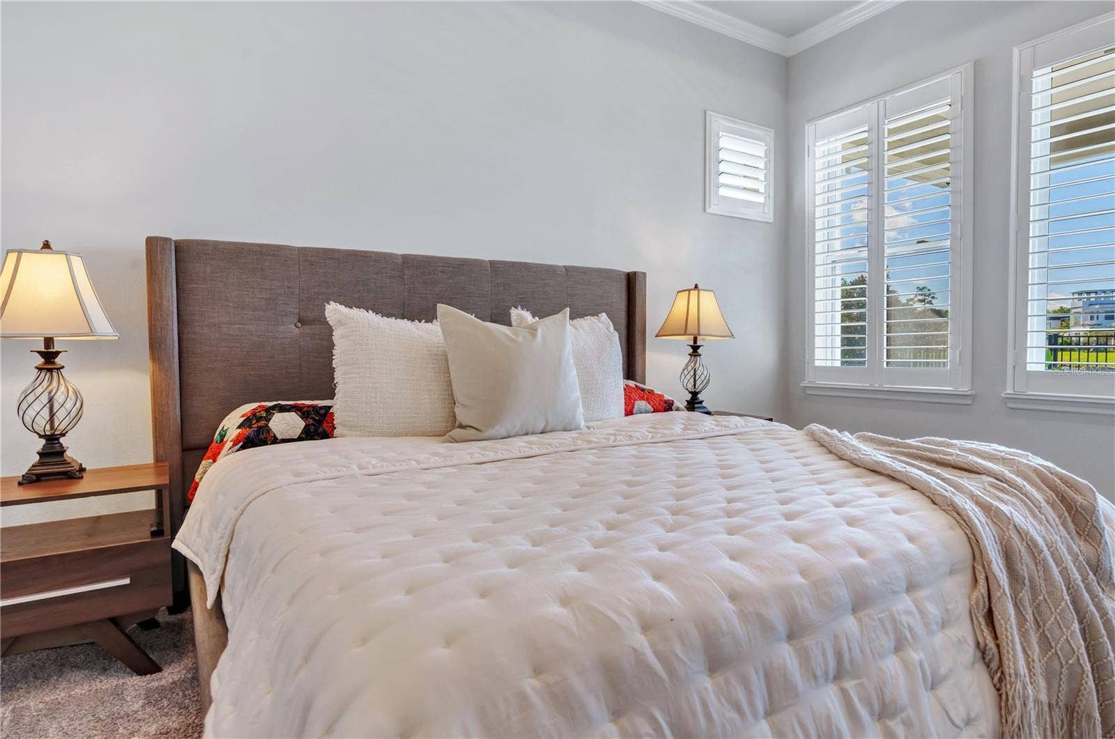 8336 CANETTI STREET, Orlando, FL 32827 Primary bedroom retreat with room for a king bed and sitting area, plush carpet, and plantation shutters.