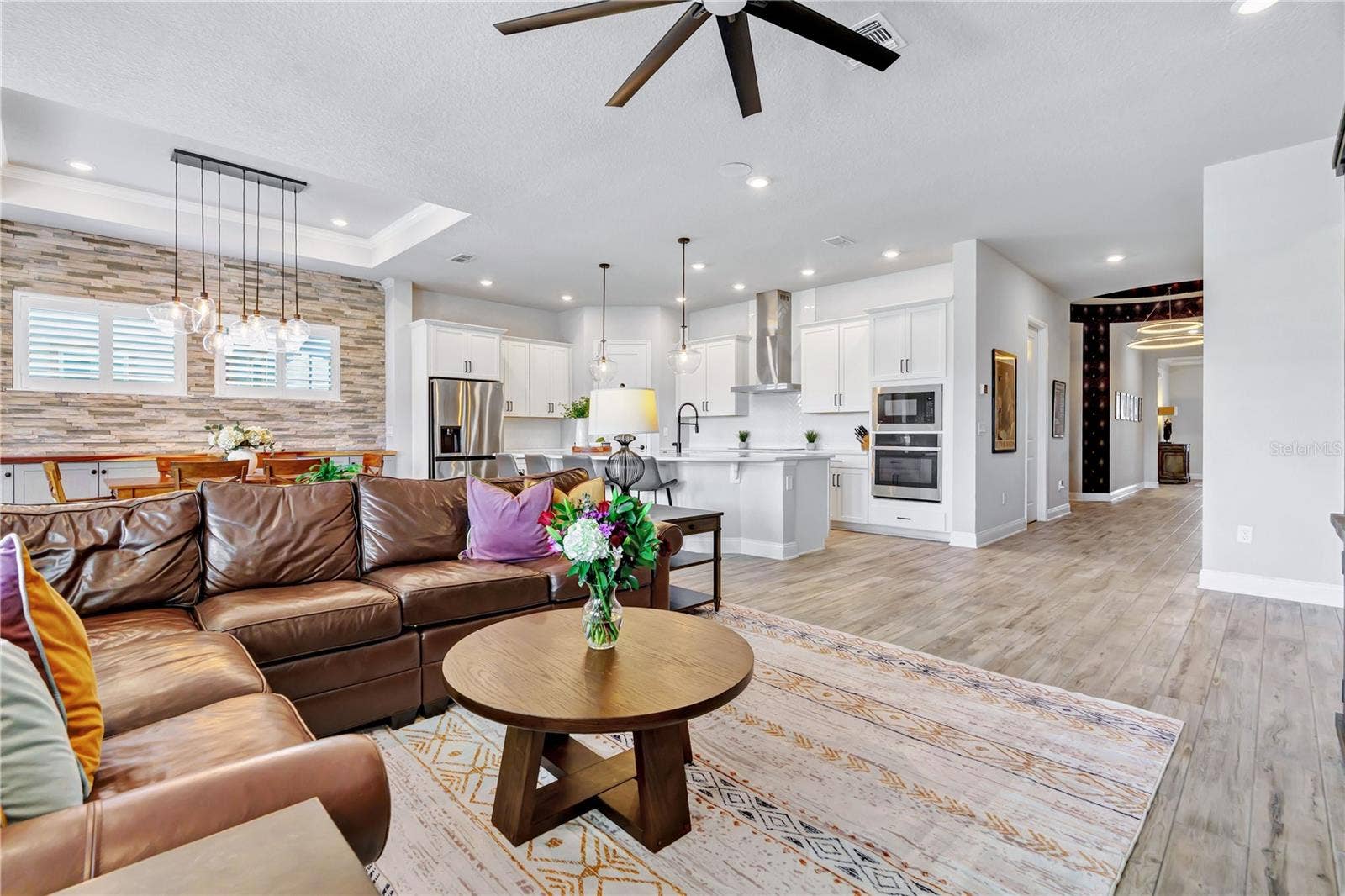 8336 CANETTI STREET, Orlando, FL 32827 Living area designed for gathering, open to the kitchen and dining space. A natural flow for entertaining in this Orlando 32827 home.