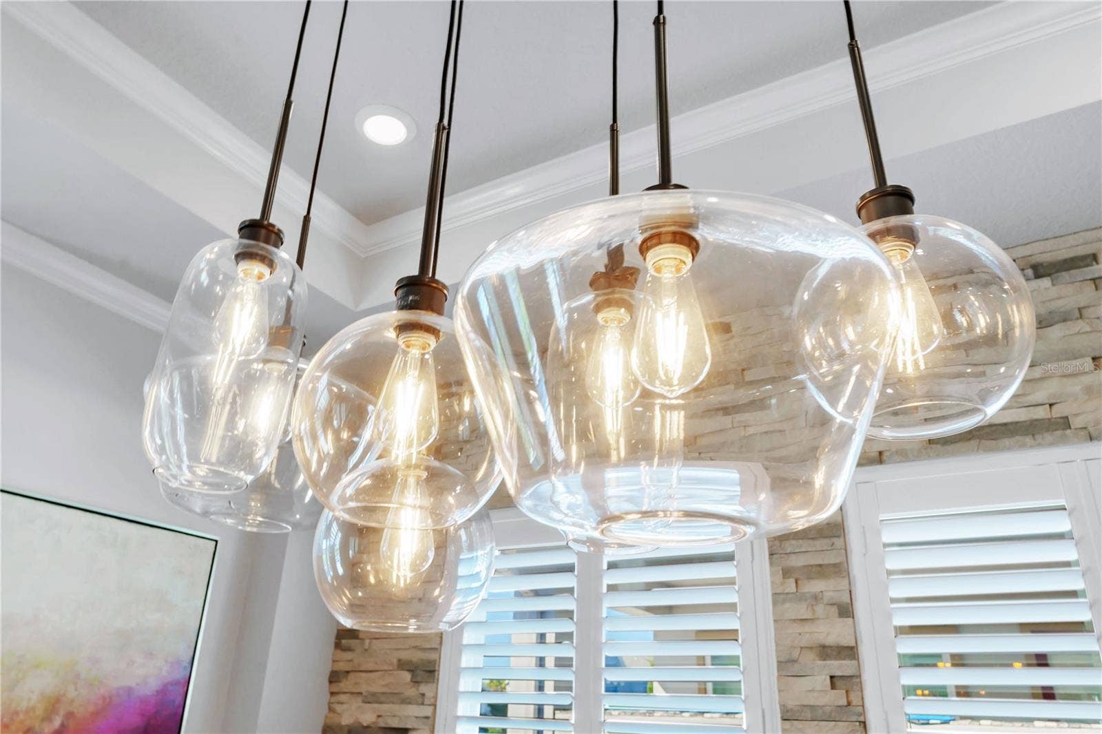 8336 CANETTI STREET, Orlando, FL 32827 Designer glass pendant lights over the dining table add warmth and style.