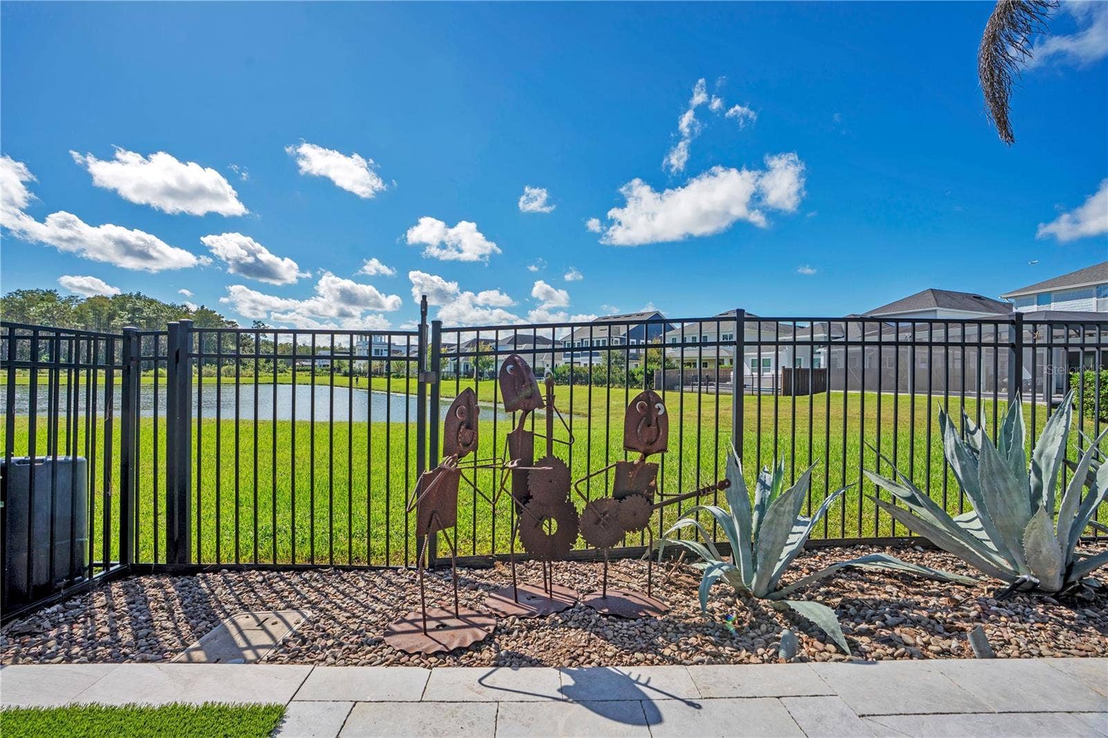 8336 CANETTI STREET, Orlando, FL 32827 Fenced backyard opening to a water and conservation view behind the home.