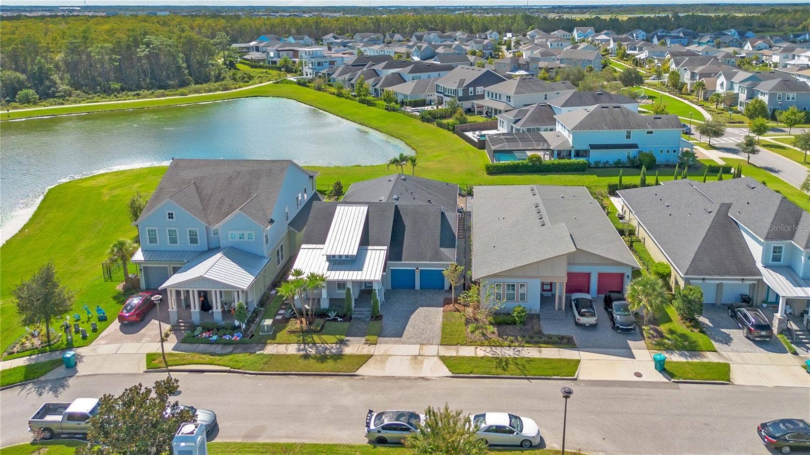 8336 CANETTI STREET, Orlando, FL 32827 Aerial of the home along the pond with water and conservation views.