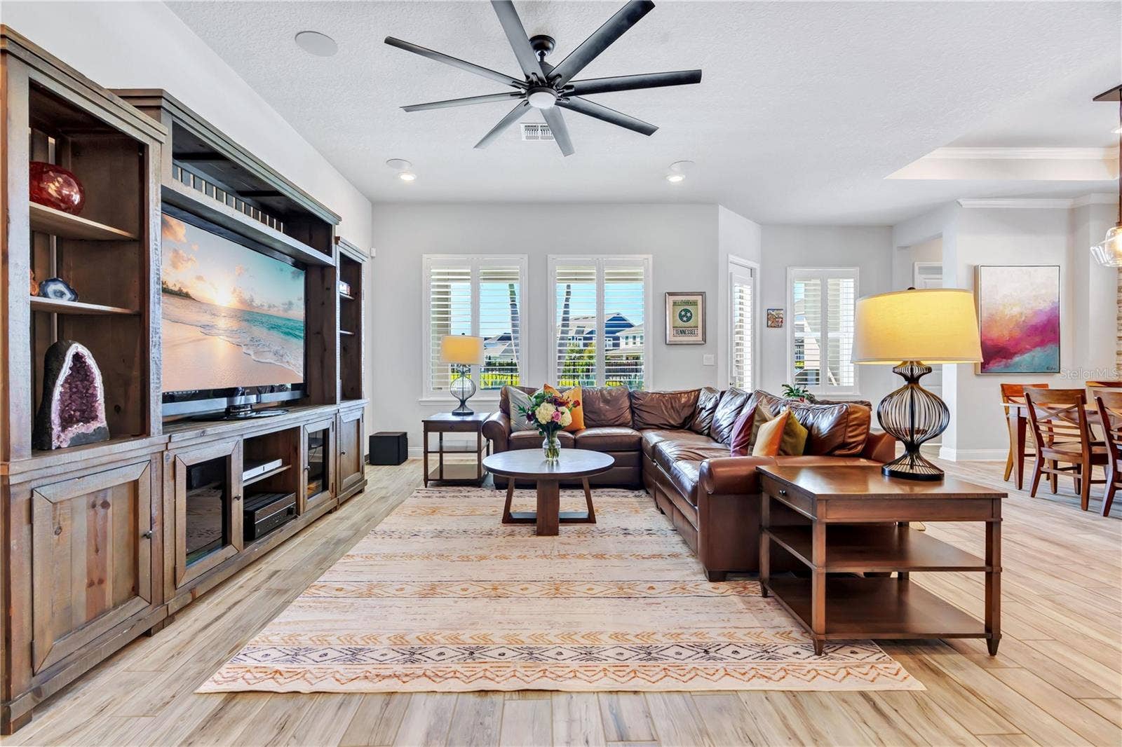 8336 CANETTI STREET, Orlando, FL 32827 Family room with custom built in entertainment center and an easy connection to the kitchen and dining area.