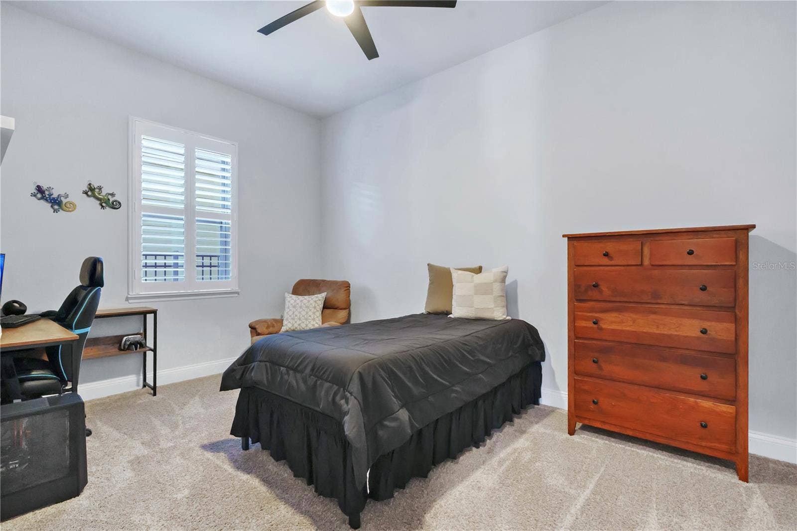 8336 CANETTI STREET, Orlando, FL 32827 Secondary bedroom with ceiling fan, carpet, and a built in closet system.