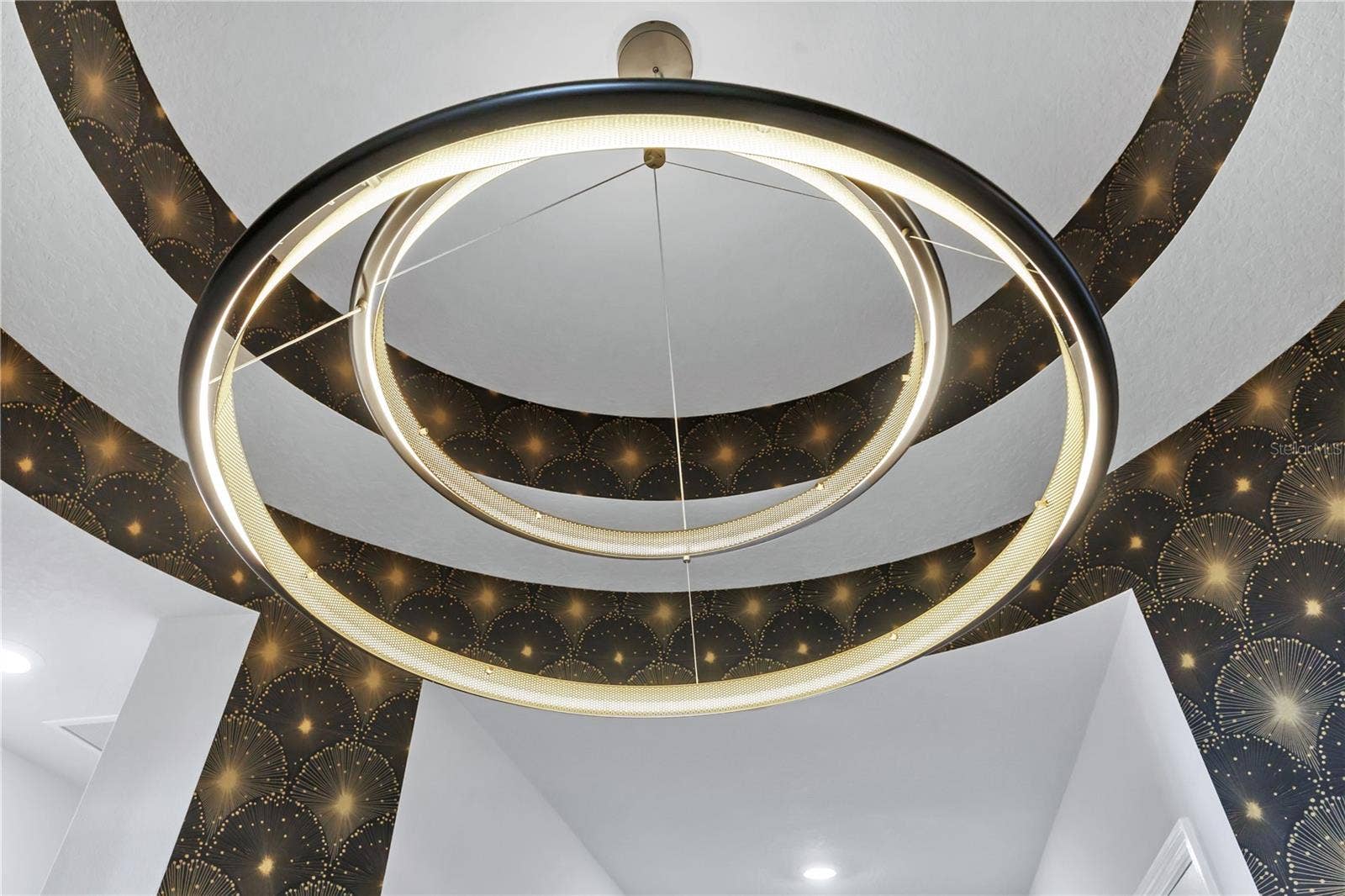 8336 CANETTI STREET, Orlando, FL 32827 Statement circular chandelier set within an accent tray ceiling. Designer details throughout this Laureate Park home.