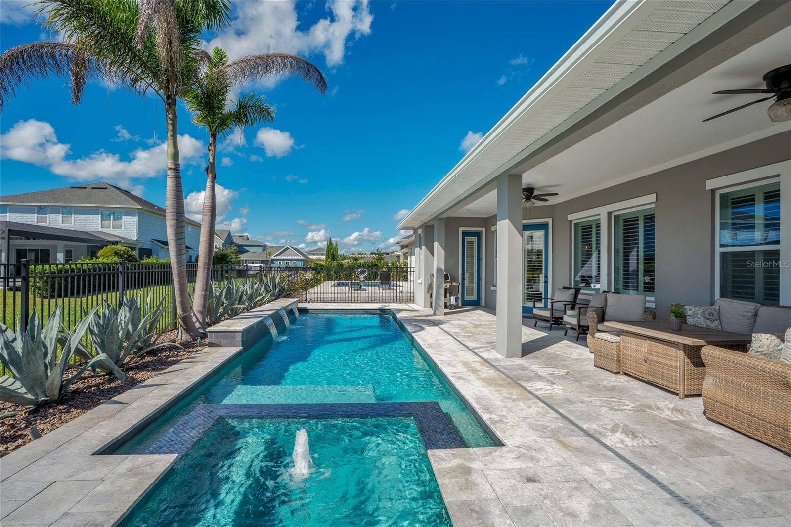 8336 CANETTI STREET, Orlando, FL 32827 Pool deck and extended lanai with room for lounging, dining, and entertaining.