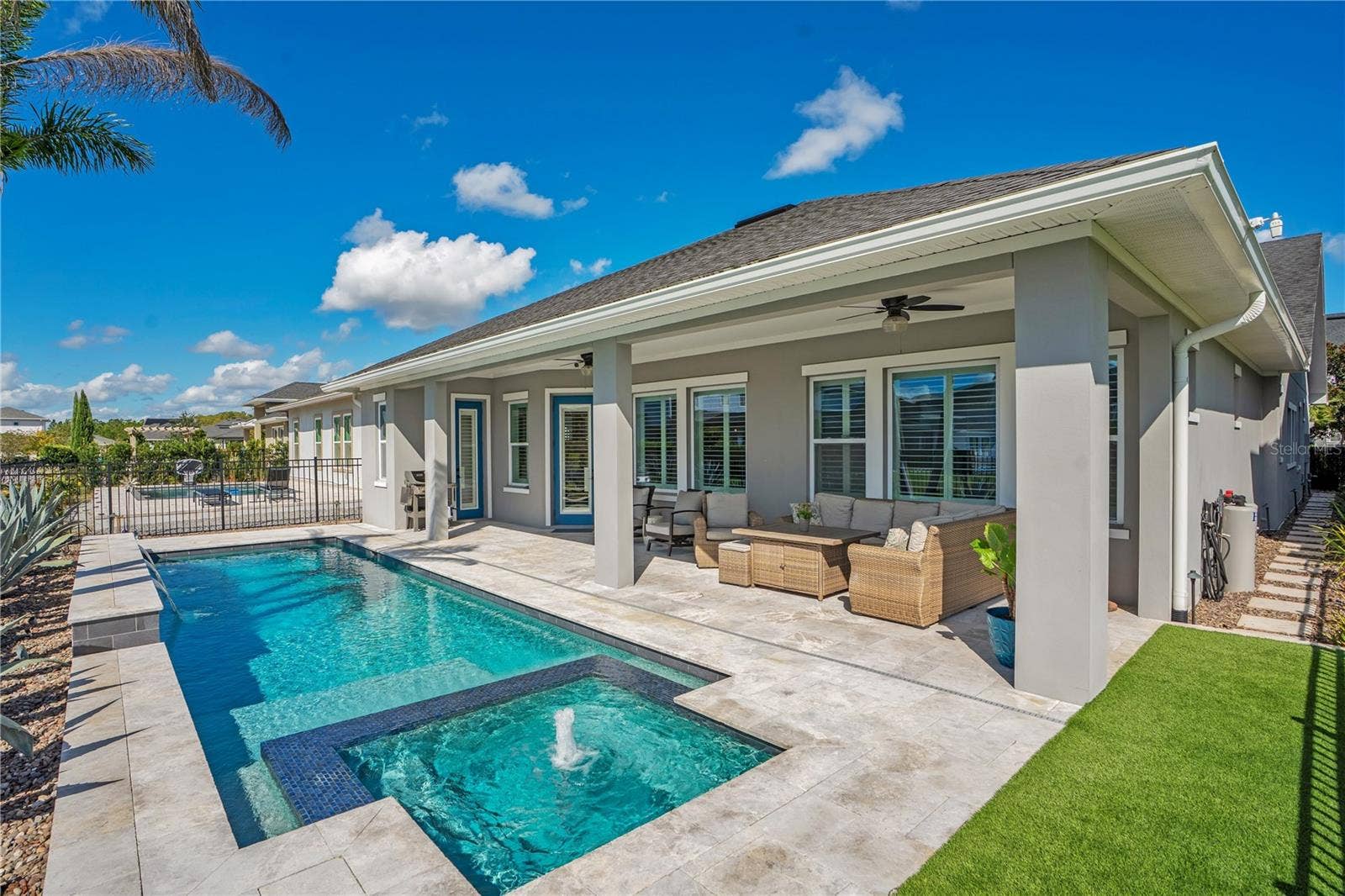 8336 CANETTI STREET, Orlando, FL 32827 Rear exterior with private heated salt water pool and covered extended lanai. Florida outdoor living in Lake Nona, Orlando.