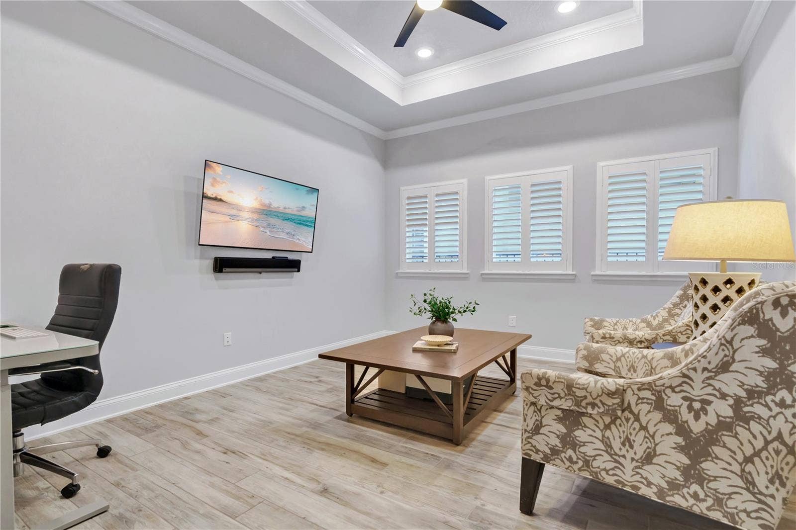 8336 CANETTI STREET, Orlando, FL 32827 Flex room with tray ceiling and plantation shutters, ready for media, work, or guests.