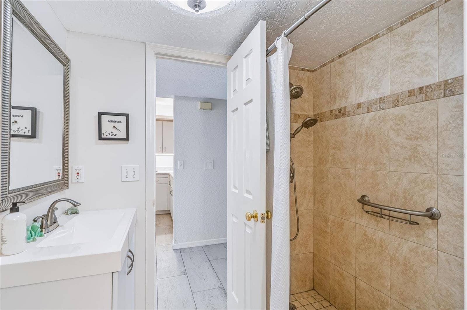 406 BOUCHELLE DRIVE, #103, New Smyrna Beach, FL 32169 bathroom with walk in shower