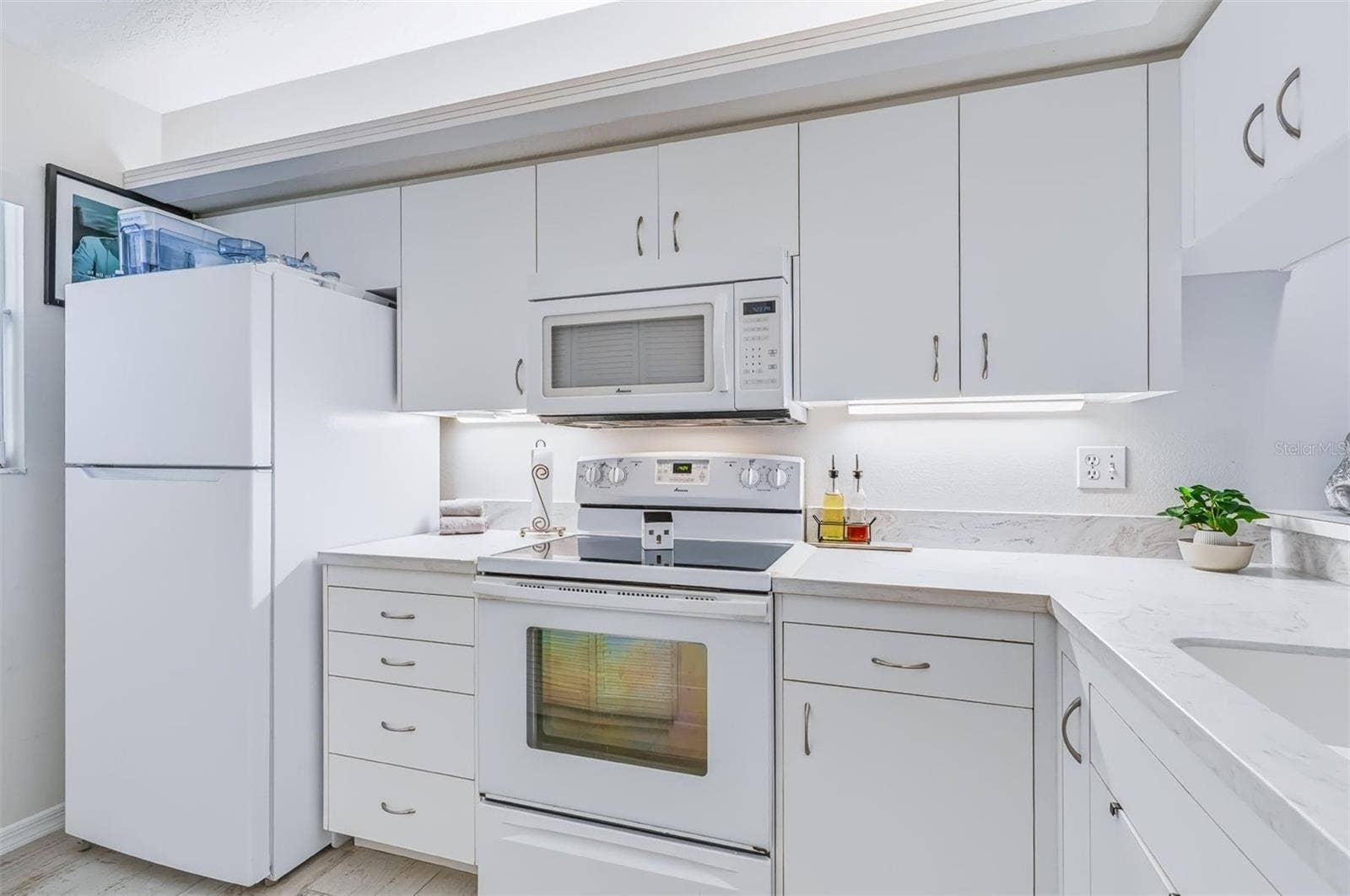 406 BOUCHELLE DRIVE, #103, New Smyrna Beach, FL 32169 kitchen with white bright appliances