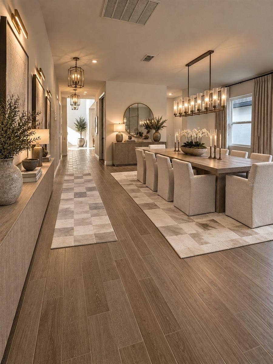 A Grand First Impression of Timeless Elegance! Step into an impressive, beautifully proportioned entryway that welcomes you with an exceptional sense of space, warmth, and sophistication. This inviting foyer offers a graceful transition into the homes expansive living areas, creating the perfect balance of architectural elegance, comfort, and refined luxury. A stunning introduction to a residence designed to feel like an exquisite model home.AI Virtual Staging Disclosure: This image has been virtually staged using artificial intelligence based on an original photograph of the actual property. Furniture, lighting, decorative finishes, and accessories are digitally generated for illustrative purposes only and are not included with the rental property.