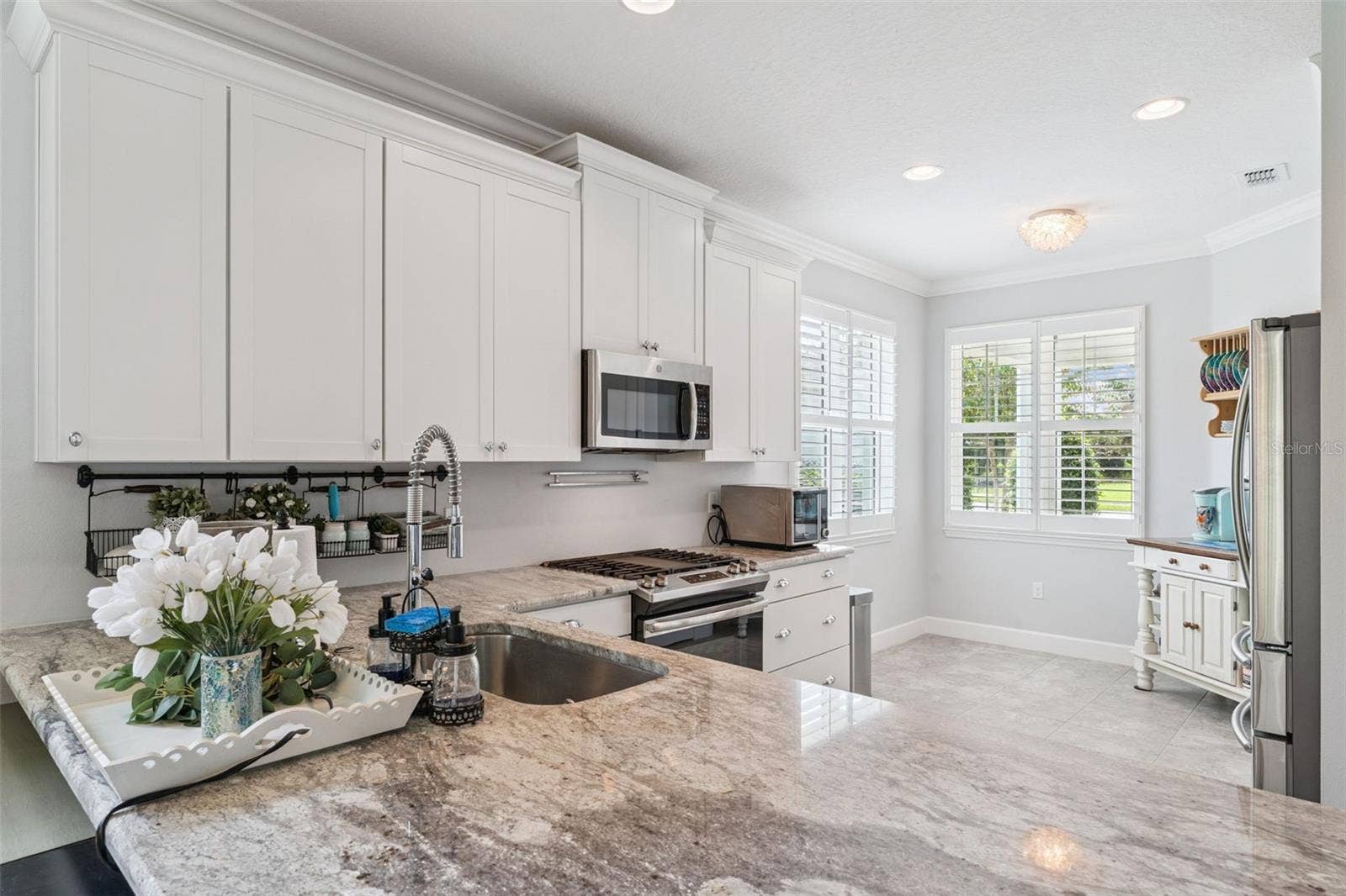 1305 HAYTON AVE., Deland, FL 32724 Kitchen w/ a single basin undermount stainless steel sink, 5-burner natural gas range & Plantation style shutters