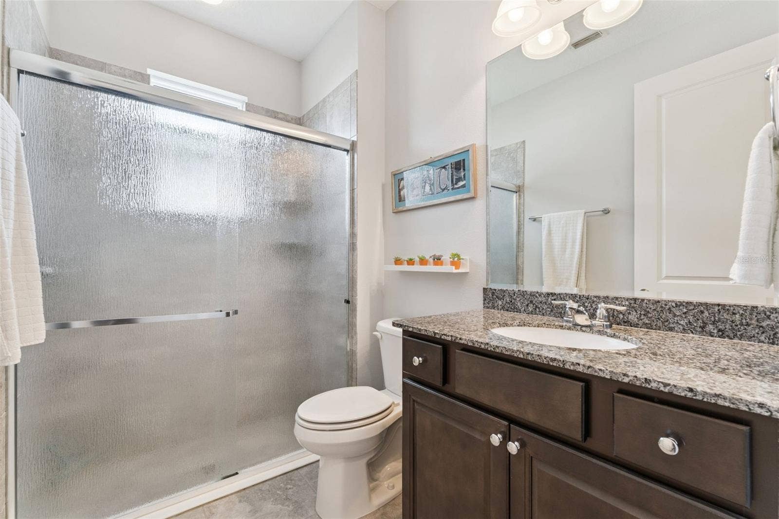 1305 HAYTON AVE., Deland, FL 32724 9' x 5'6" Guest Bathroom w/ walk-in shower & sliding glass door